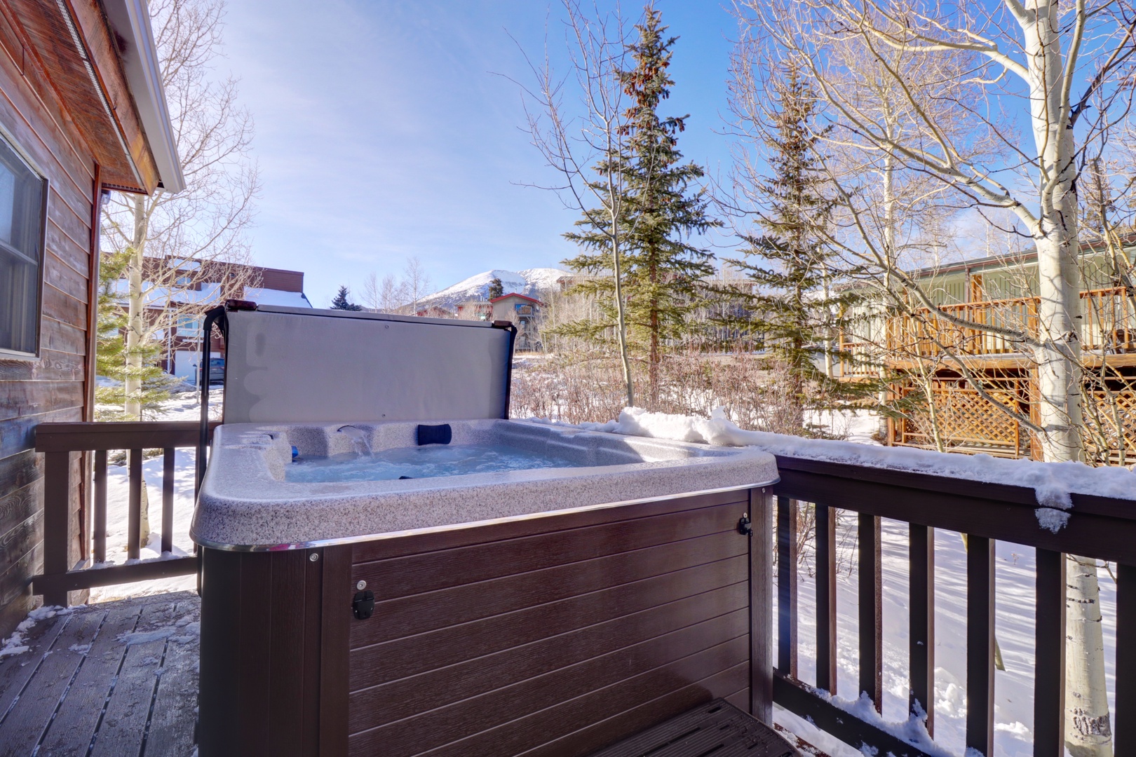 Soak in your private hot tub while snow-capped mountains create a stunning winter backdrop for your mountain getaway.