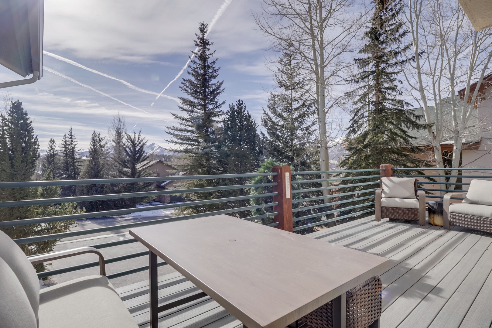 Step onto your private deck where mountain vistas and evergreen forests create your perfect morning coffee backdrop.