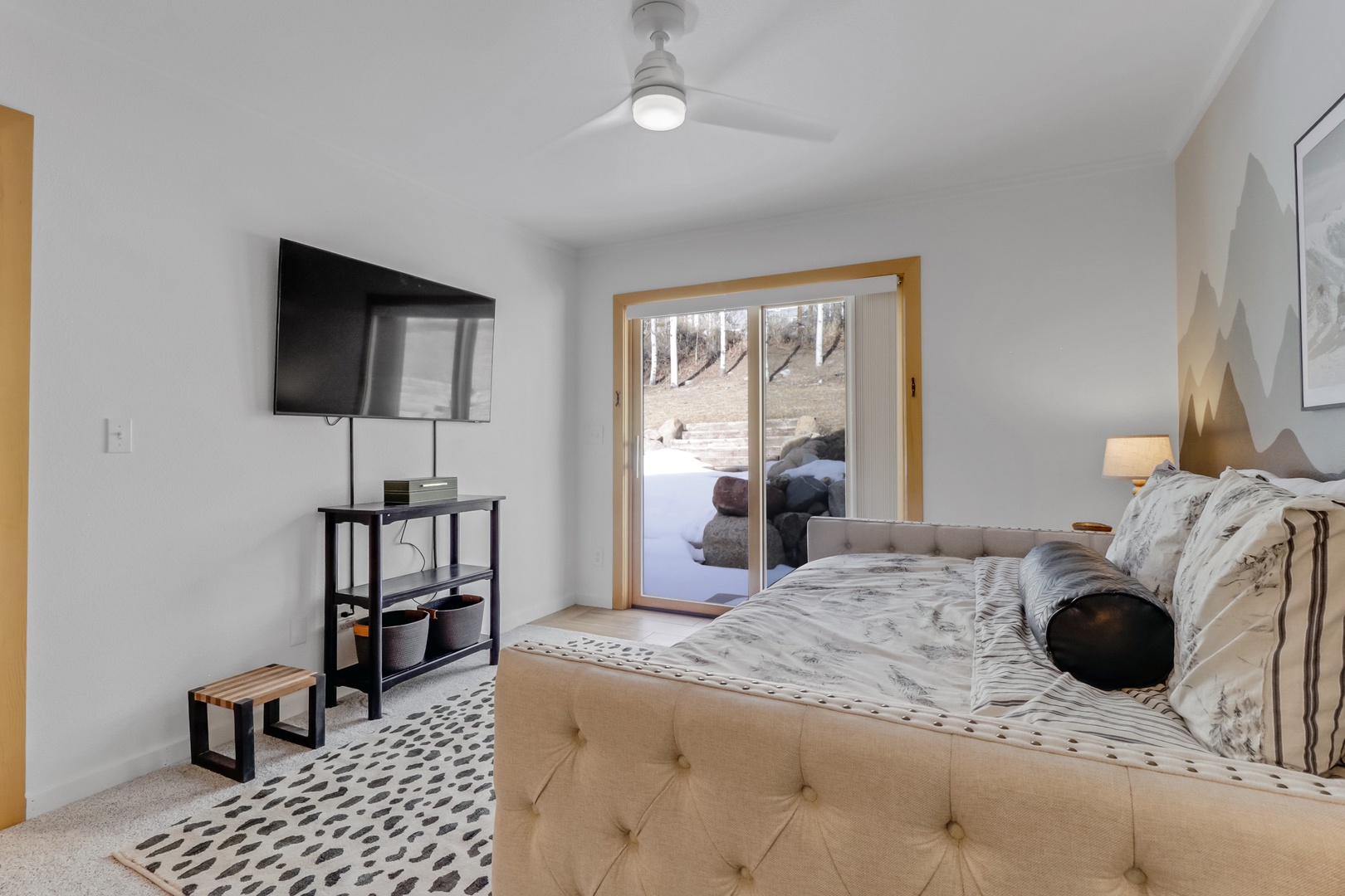 Unwind in your cozy retreat with mountain views, modern TV, and serene patio access for peaceful moments.