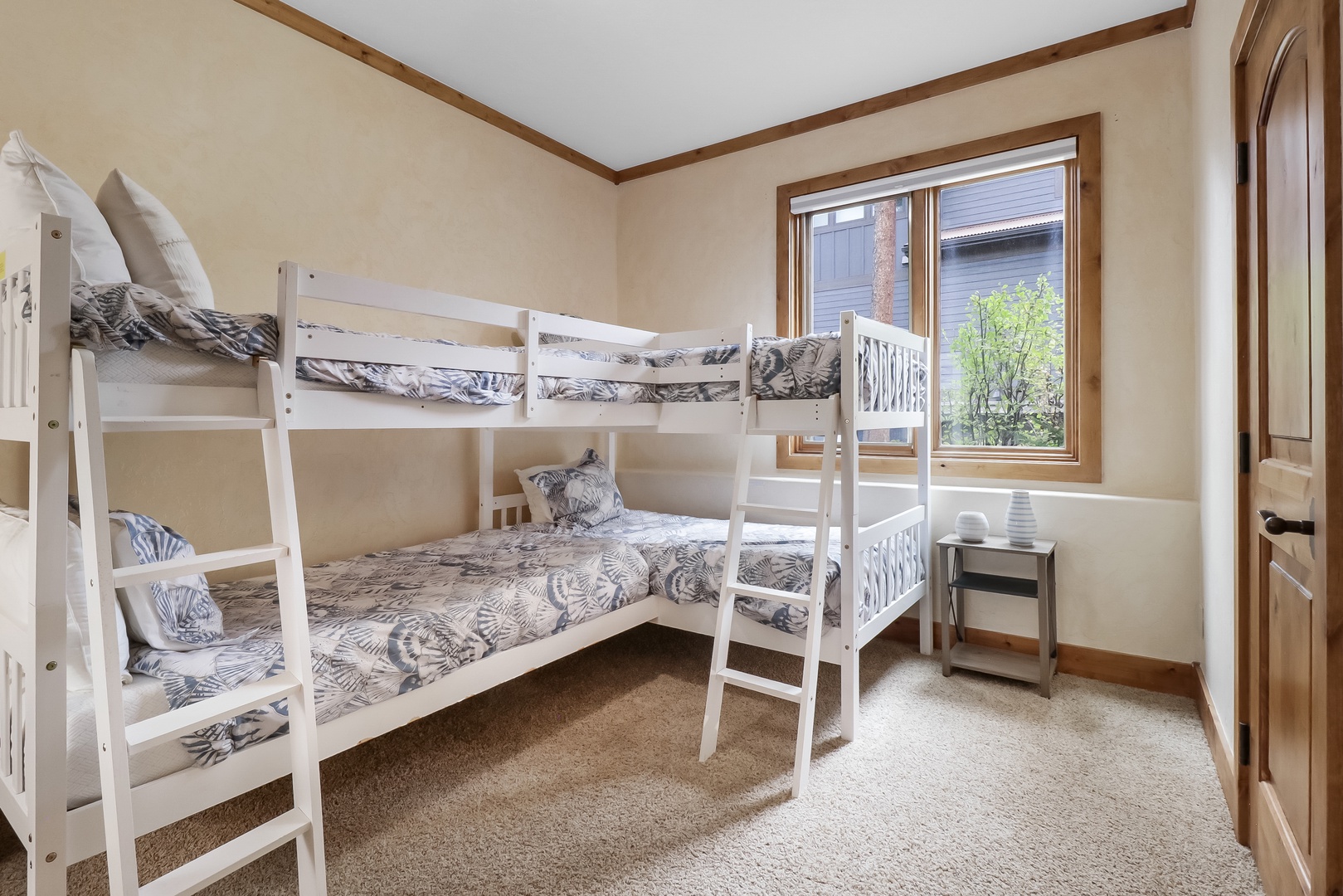 You'll love this cozy bunk room with two twin-over-twin beds, perfect for kids or extra guests. Natural light floods in through the window, and plush pillows make bedtime feel like an adventure.