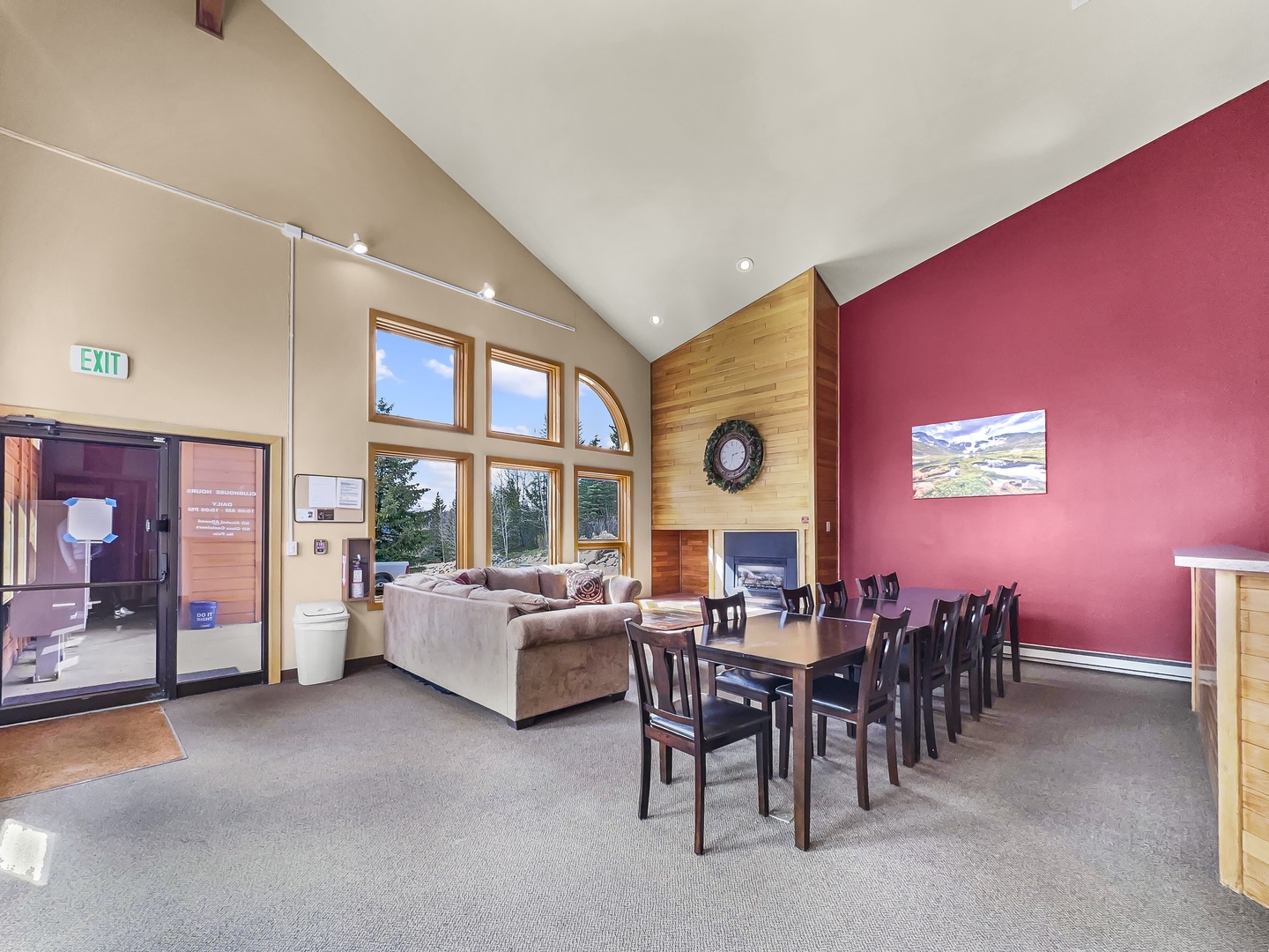 Gather around the spacious dining table for memorable meals while enjoying the cozy fireplace and stunning mountain views through soaring windows.