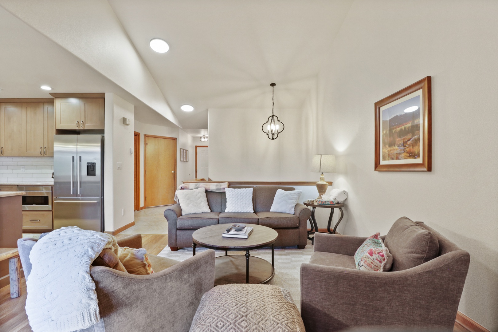 Sink into plush seating where natural light dances across warm wood floors, creating your perfect retreat.