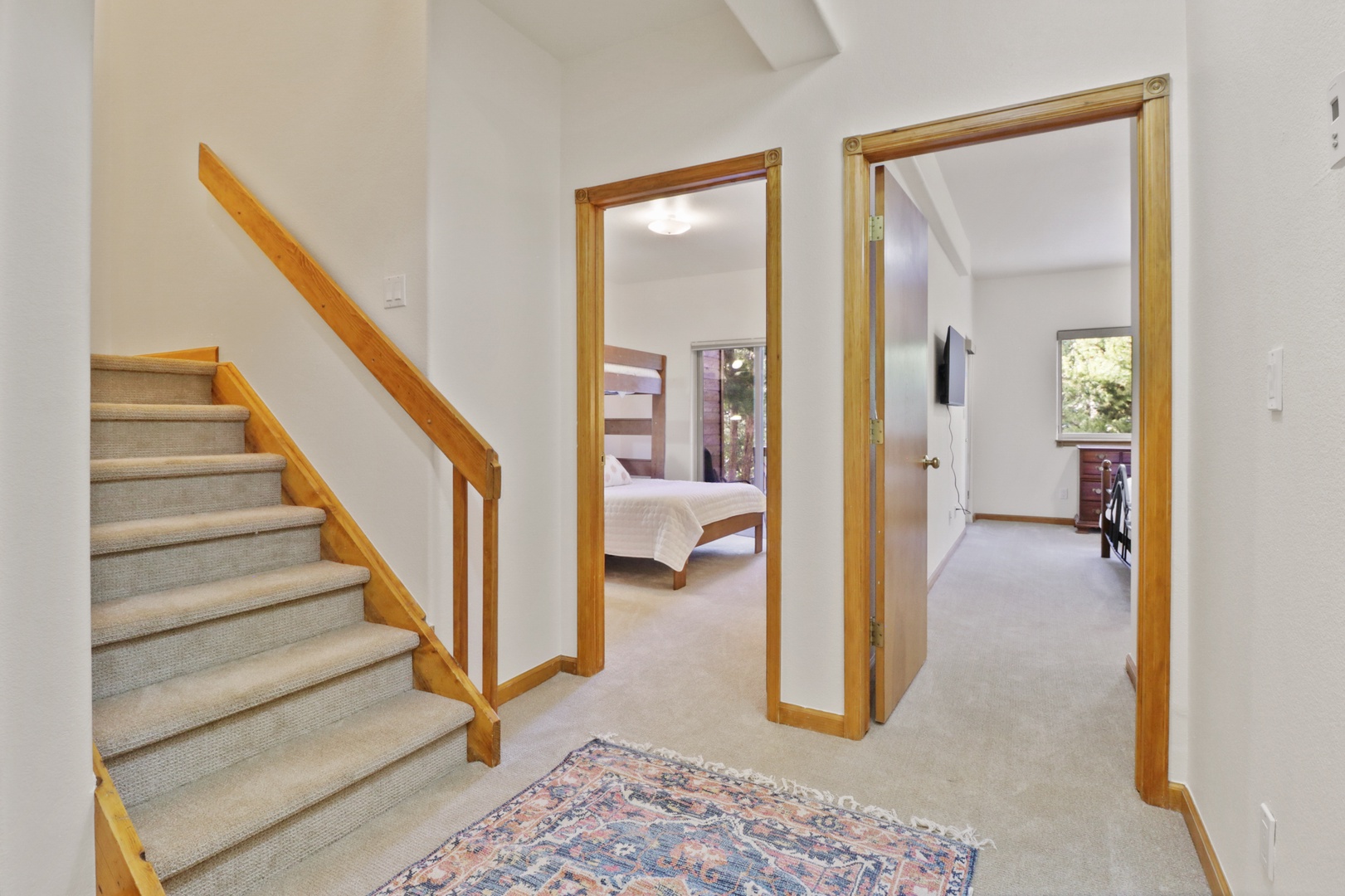 Step into your welcoming hallway with warm wood accents and carpet underfoot, where multiple levels invite exploration.