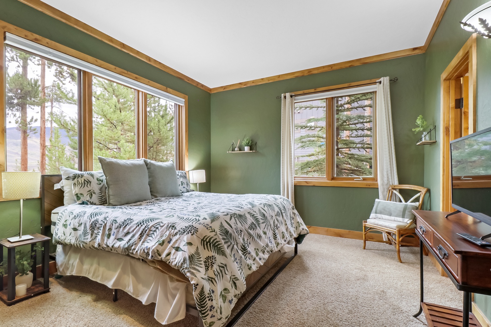 Sink into soft linens surrounded by tranquil forest views. Your private bedroom offers serene green tones, peaceful natural light, and cozy comfort—your mountain escape begins here.