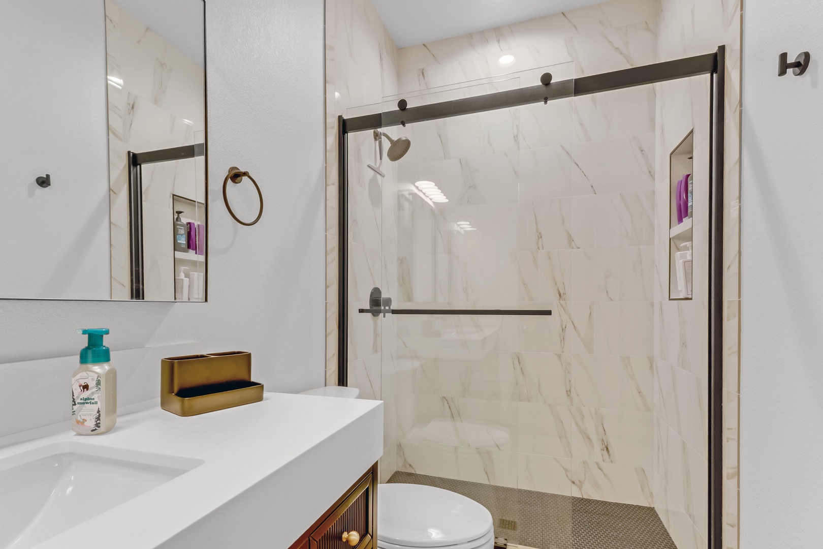 Step into your spa-like bathroom retreat with elegant marble walls and a spacious glass shower that invites pure relaxation.