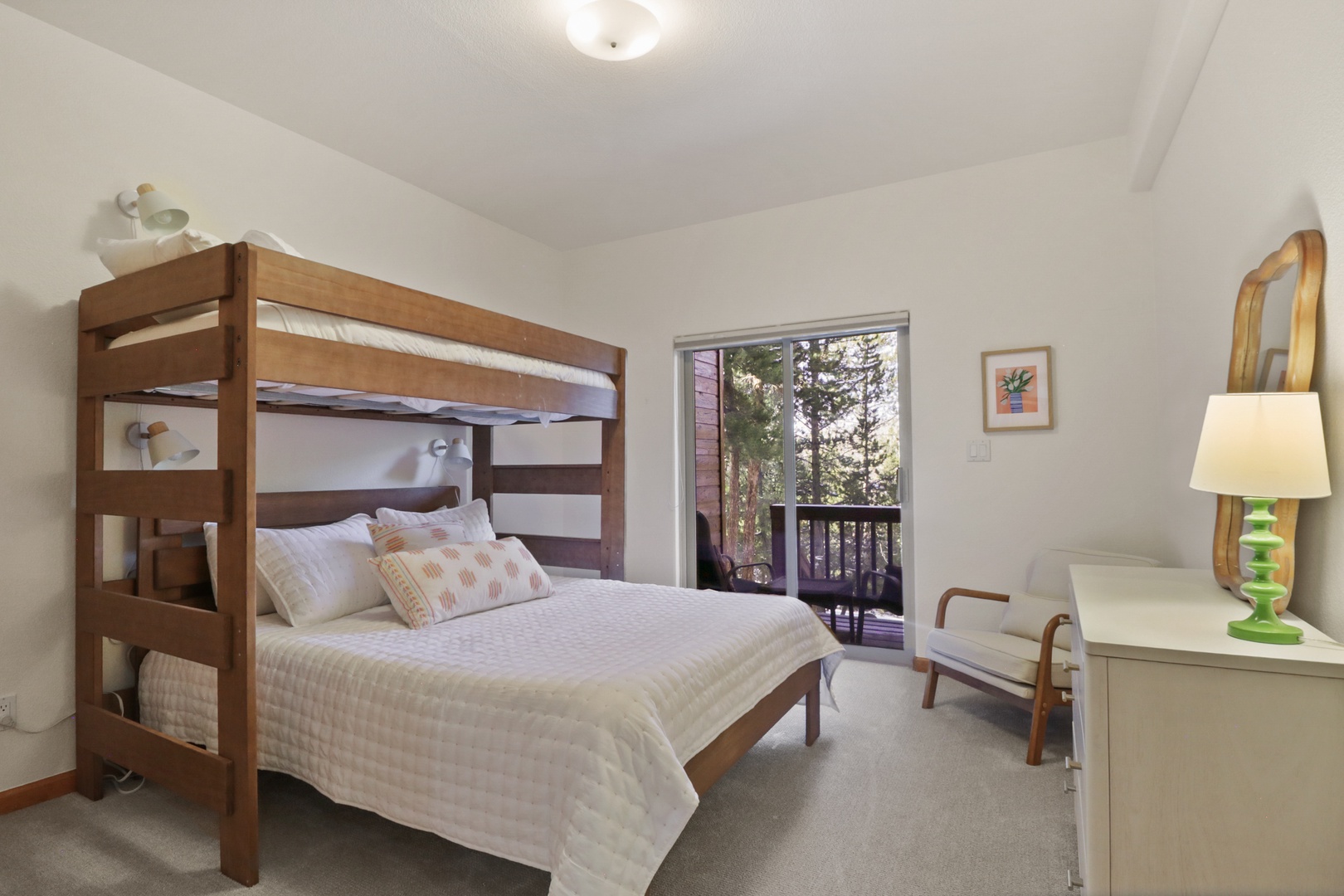 Your cozy bedroom features a clever bunk bed setup with crisp white linens and warm wood accents, perfect for families.