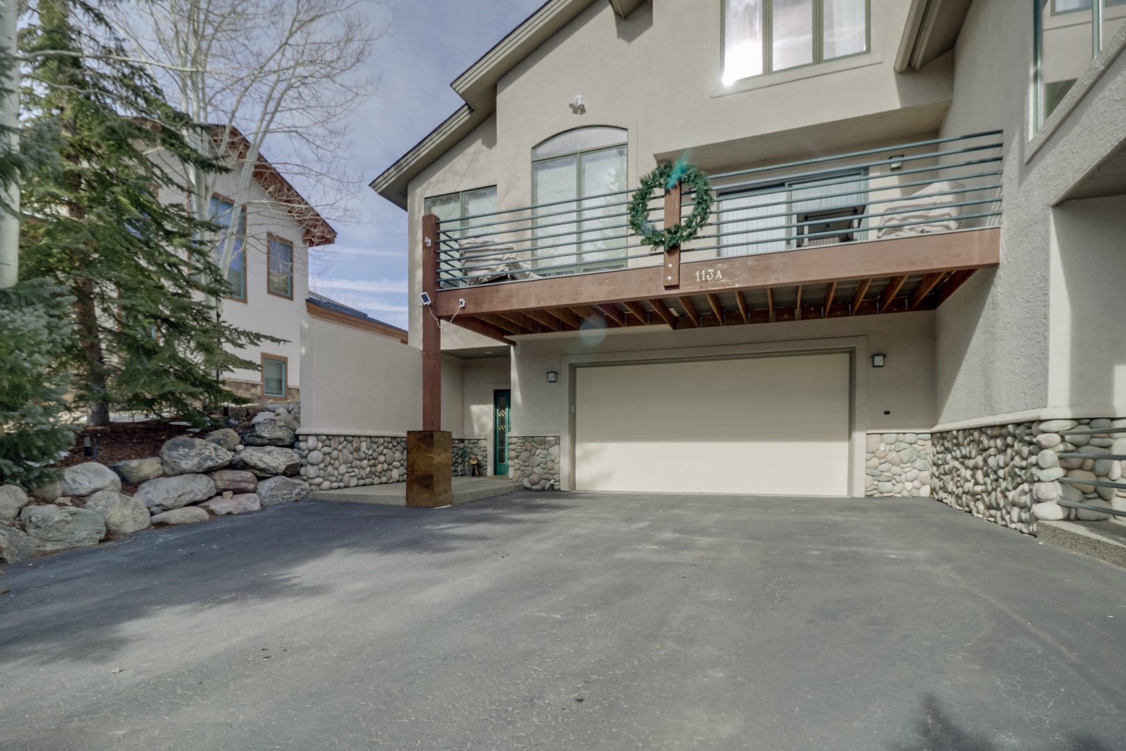 Modern mountain home with stone accents and spacious garage for all your adventure gear.