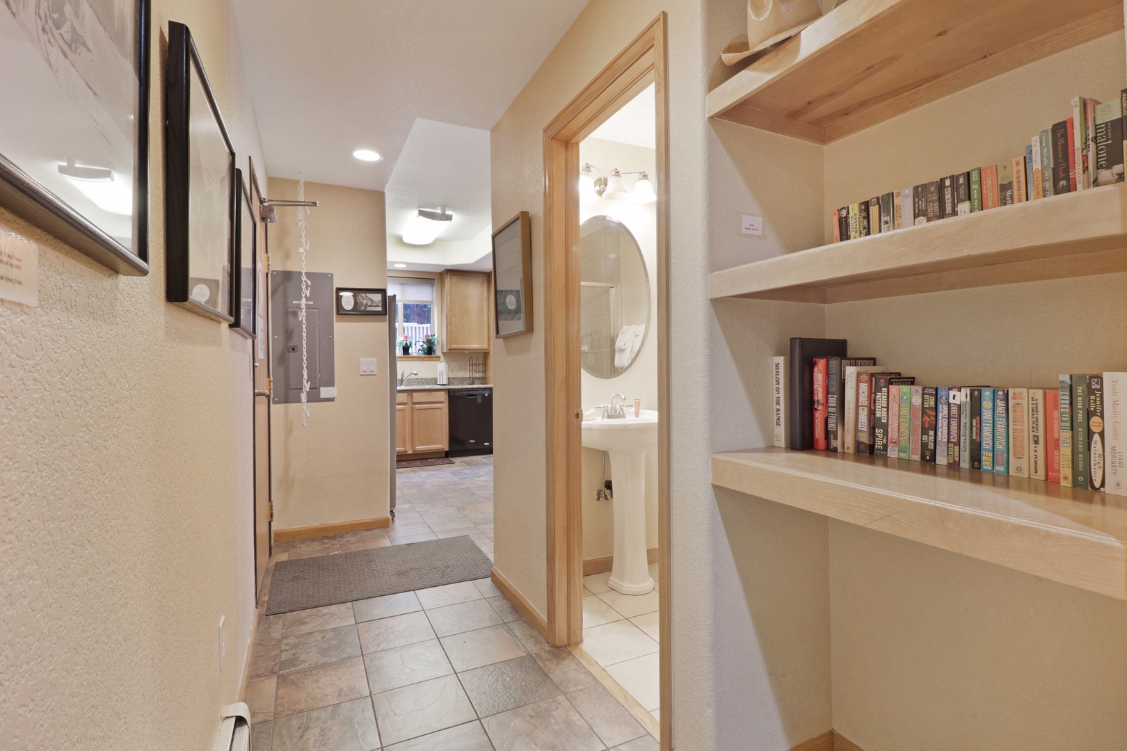 Step inside your cozy retreat where warm wood tones and built-in shelving create a welcoming space. The open layout connects you seamlessly to the kitchen and bathroom, making everything you need close at hand.