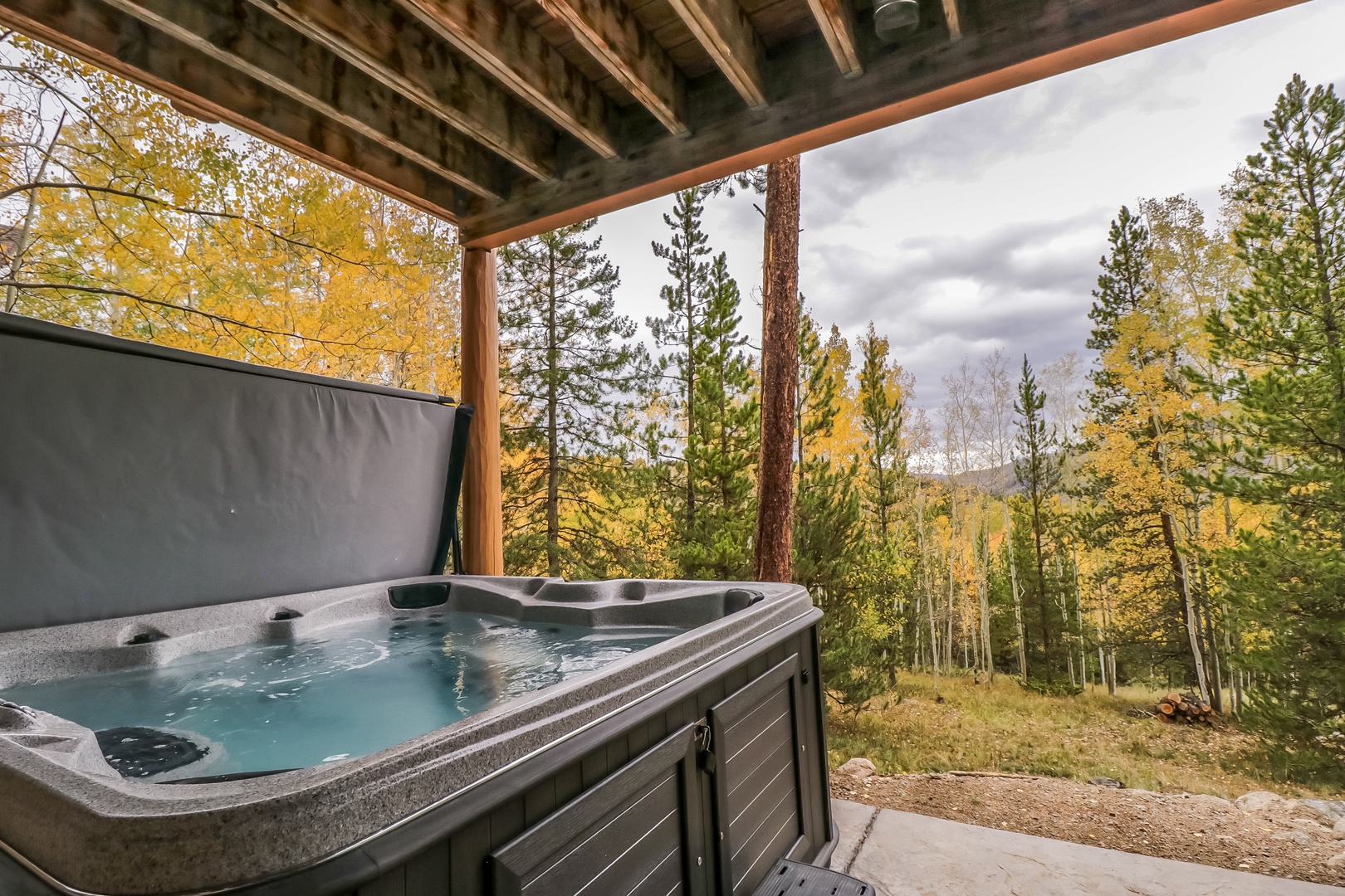 Soak in your private hot tub under a covered terrace while golden aspens frame mountain views, offering peaceful relaxation surrounded by autumn's natural beauty.