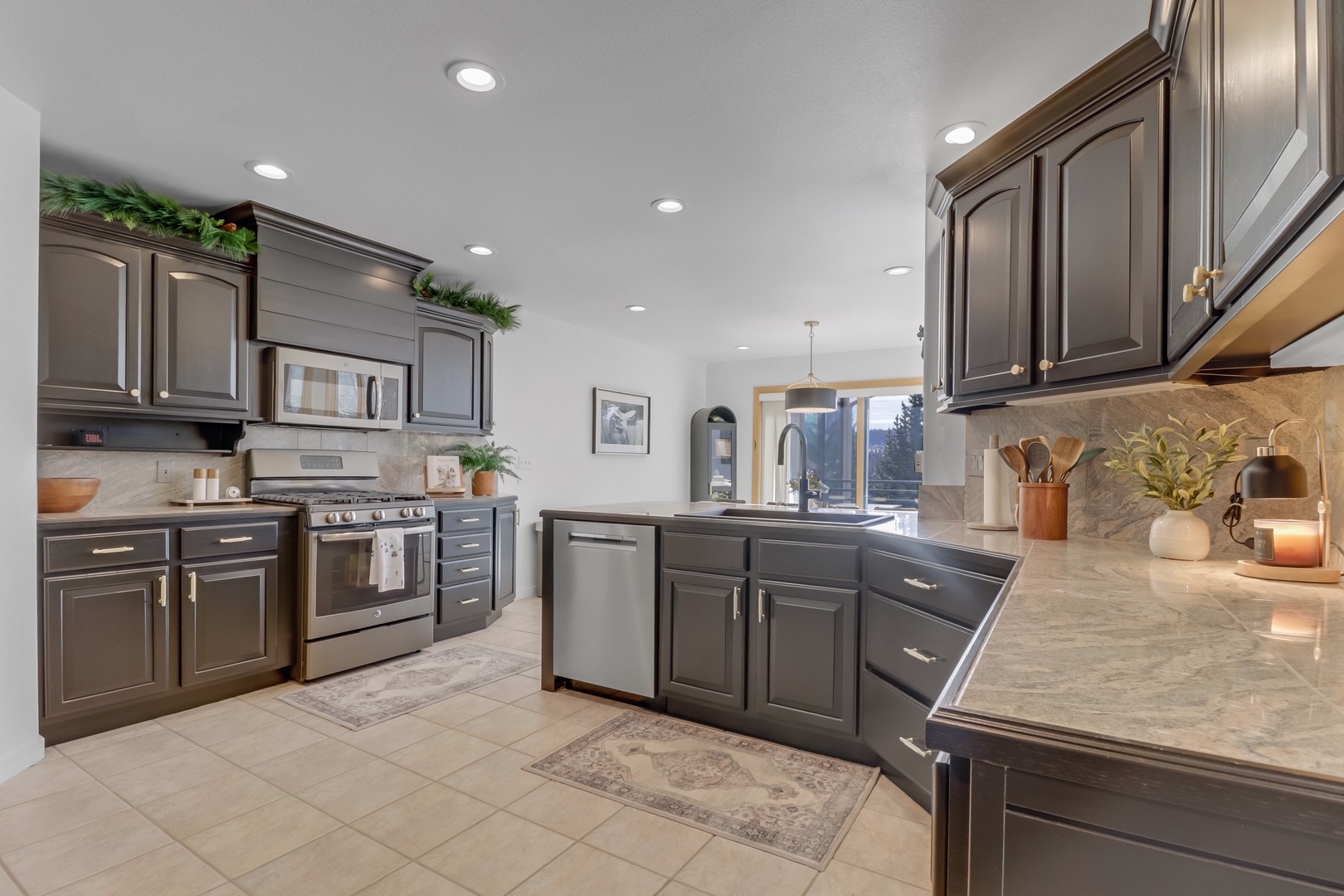 Your gourmet kitchen awaits with sleek granite countertops, stainless steel appliances, and warm ambient lighting perfect for preparing memorable meals.