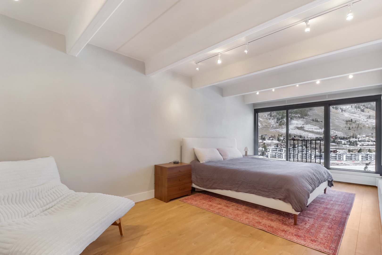 Rest peacefully in your bright bedroom with exposed beam ceilings and breathtaking mountain valley views right from your window.