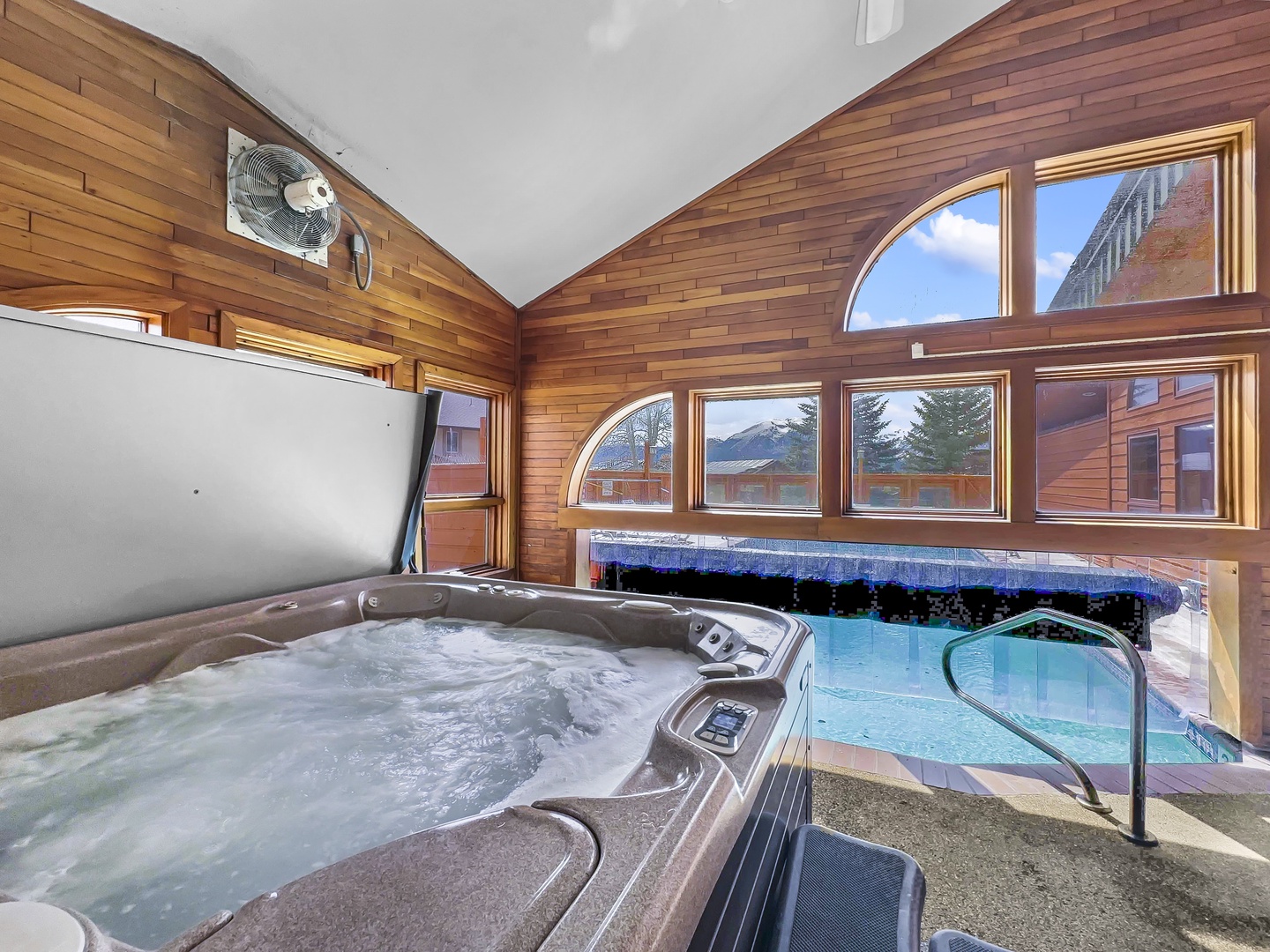 Unwind in your public hot tub while soaking in mountain views through floor-to-ceiling windows in this luxurious spa retreat.