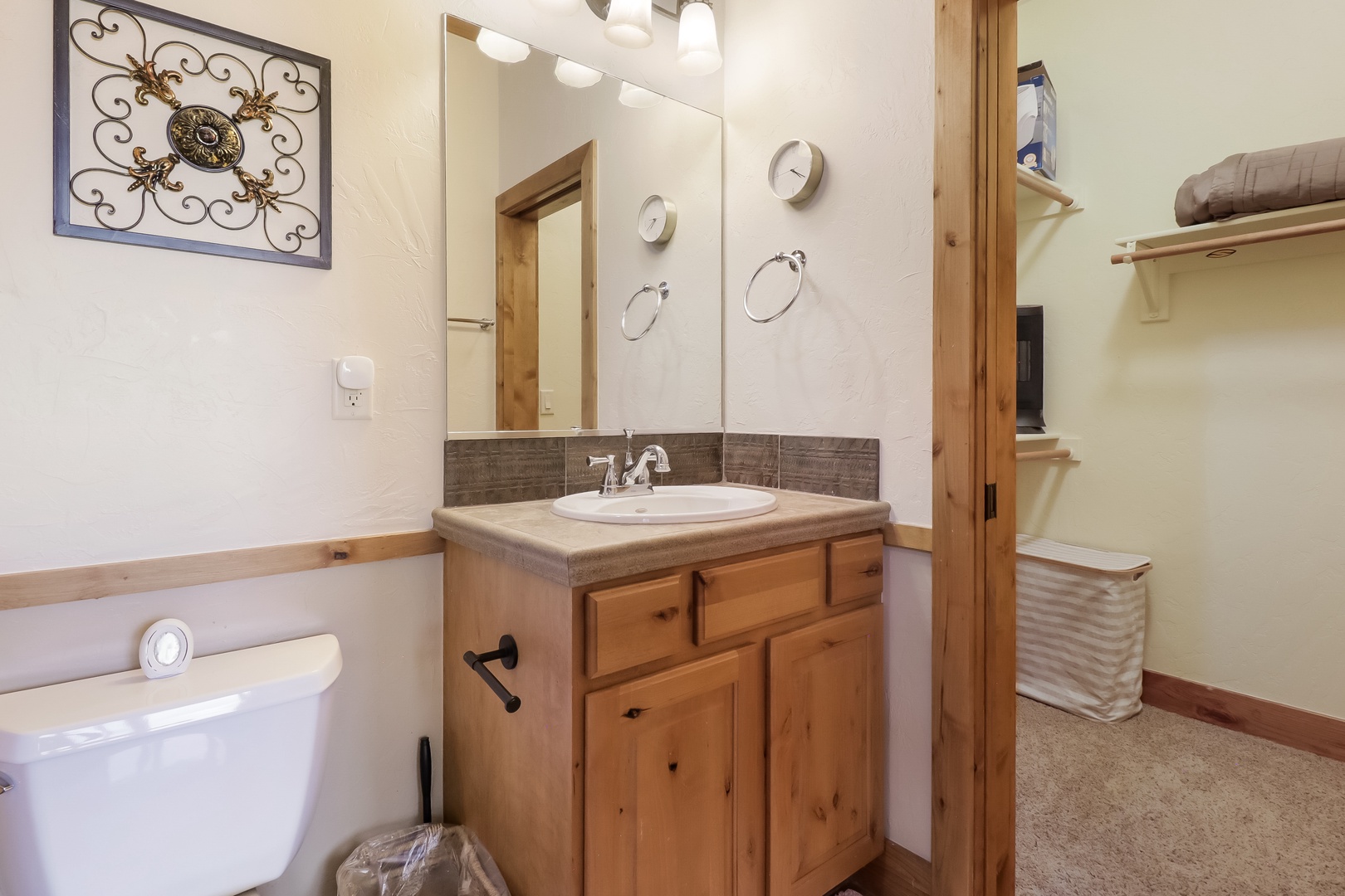 Your private bathroom features warm wood finishes, ample storage, and fresh linens, creating a cozy retreat where you can freshen up in comfort and style.