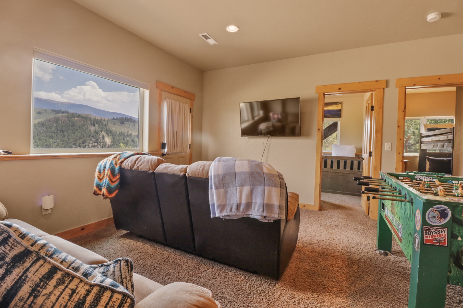 Curl up on the cozy sofa and gaze at those stunning mountain views through the window. With a foosball table for entertainment and easy access to the bedroom, your mountain retreat awaits.