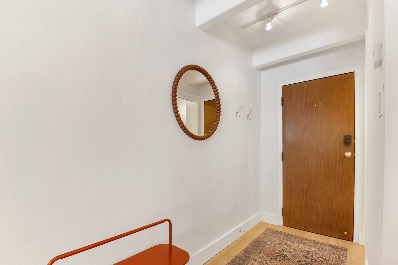 Step into your welcoming entryway with warm wood touches, decorative mirror, and thoughtful lighting that sets the tone for your stay.