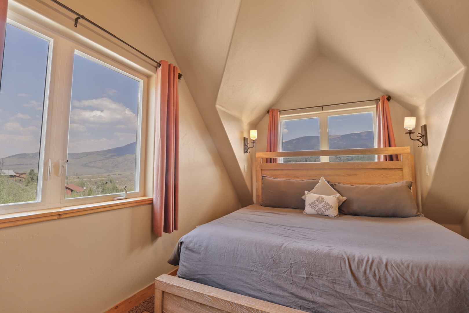 Wake up to stunning mountain views from this cozy bedroom, where natural light fills the airy loft and soft linens invite peaceful mornings.