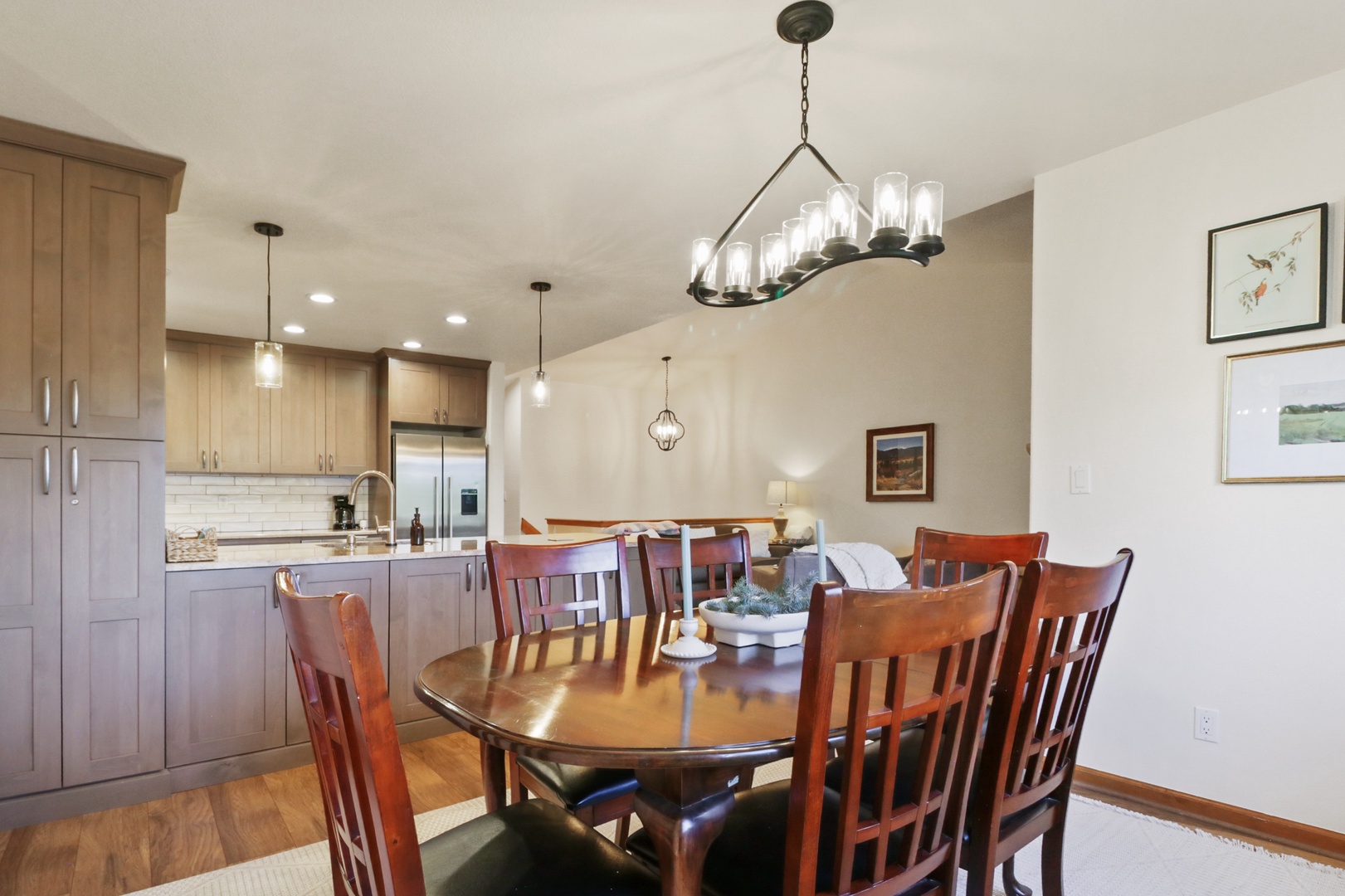Gather around your spacious dining table under elegant chandelier lighting, with the fully-equipped kitchen just steps away for effortless meal prep.