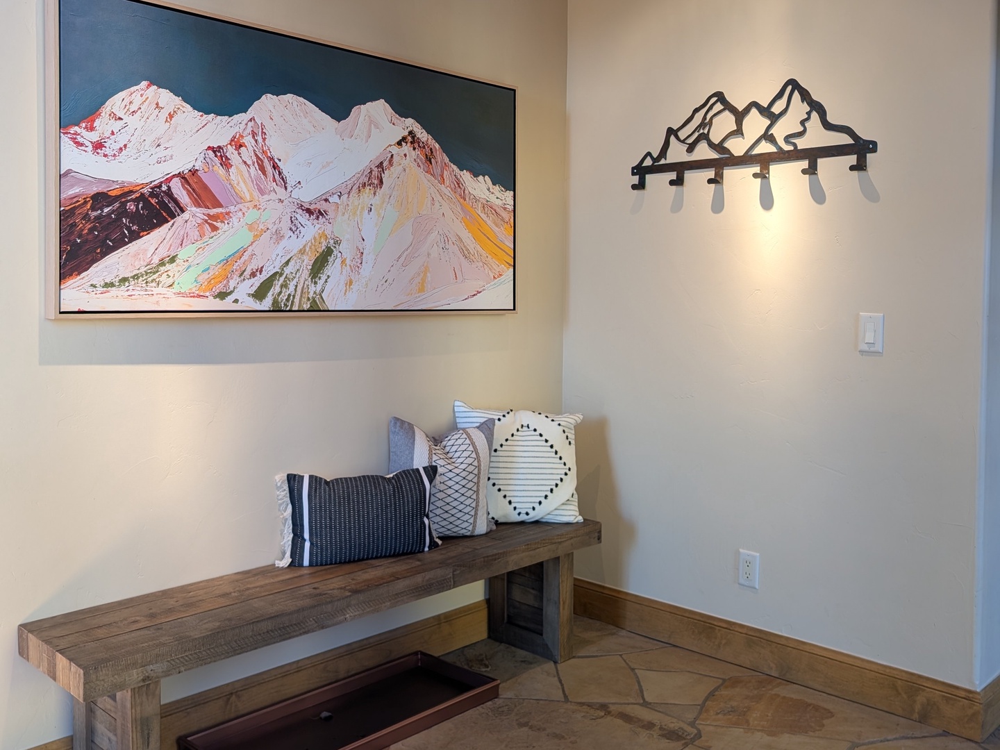 Updated oversized bench and coat hooks in the entryway.