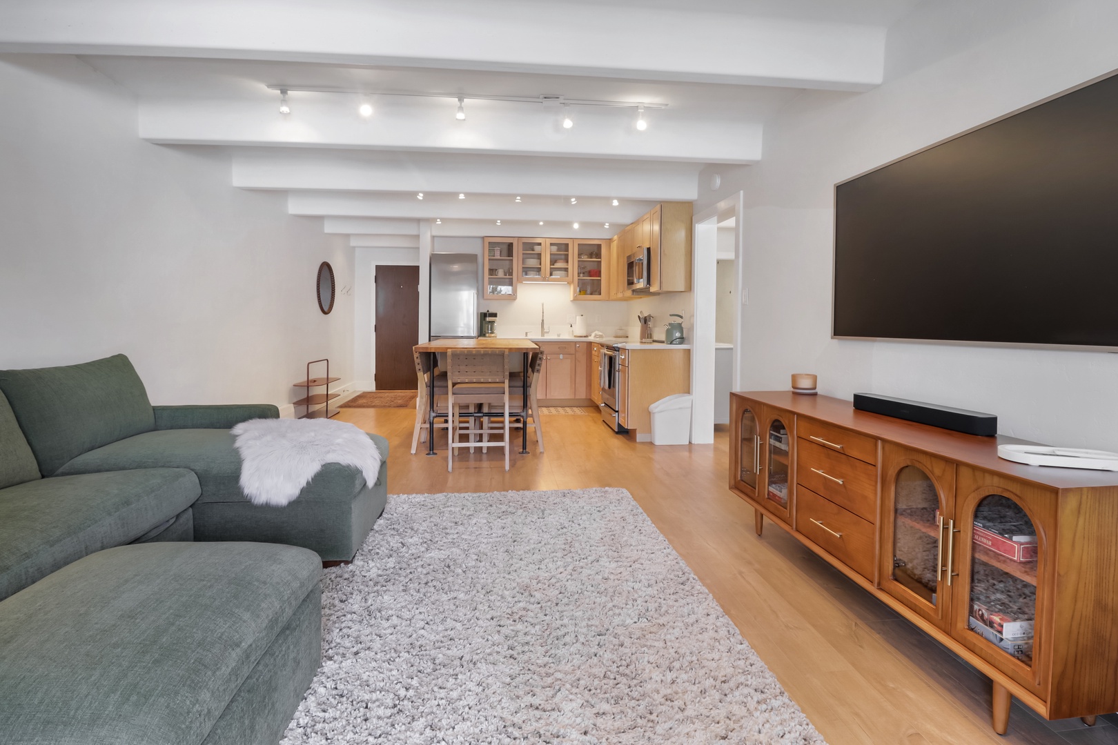 Relax in your stylish open-plan space with exposed beams, plush seating, and a fully equipped kitchen for memorable meals.