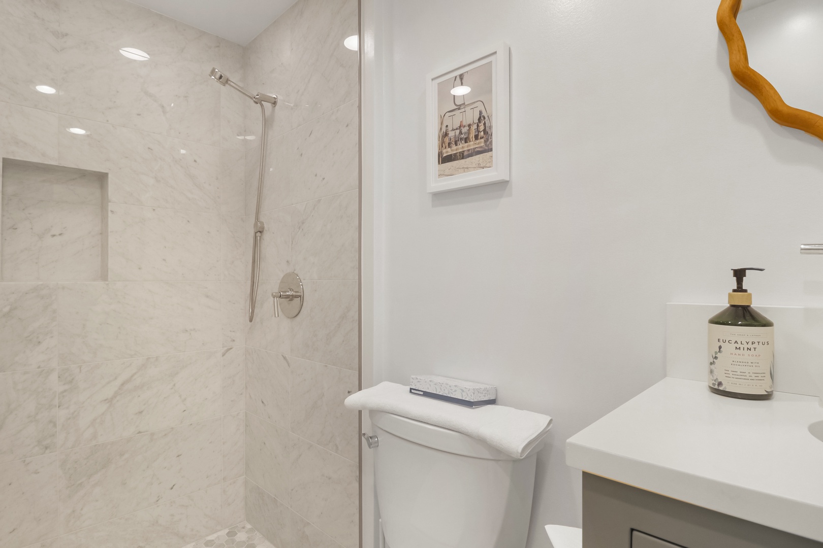 Step into your pristine marble bathroom featuring a rainfall shower, elegant fixtures, and thoughtful touches like premium toiletries to make you feel pampered.