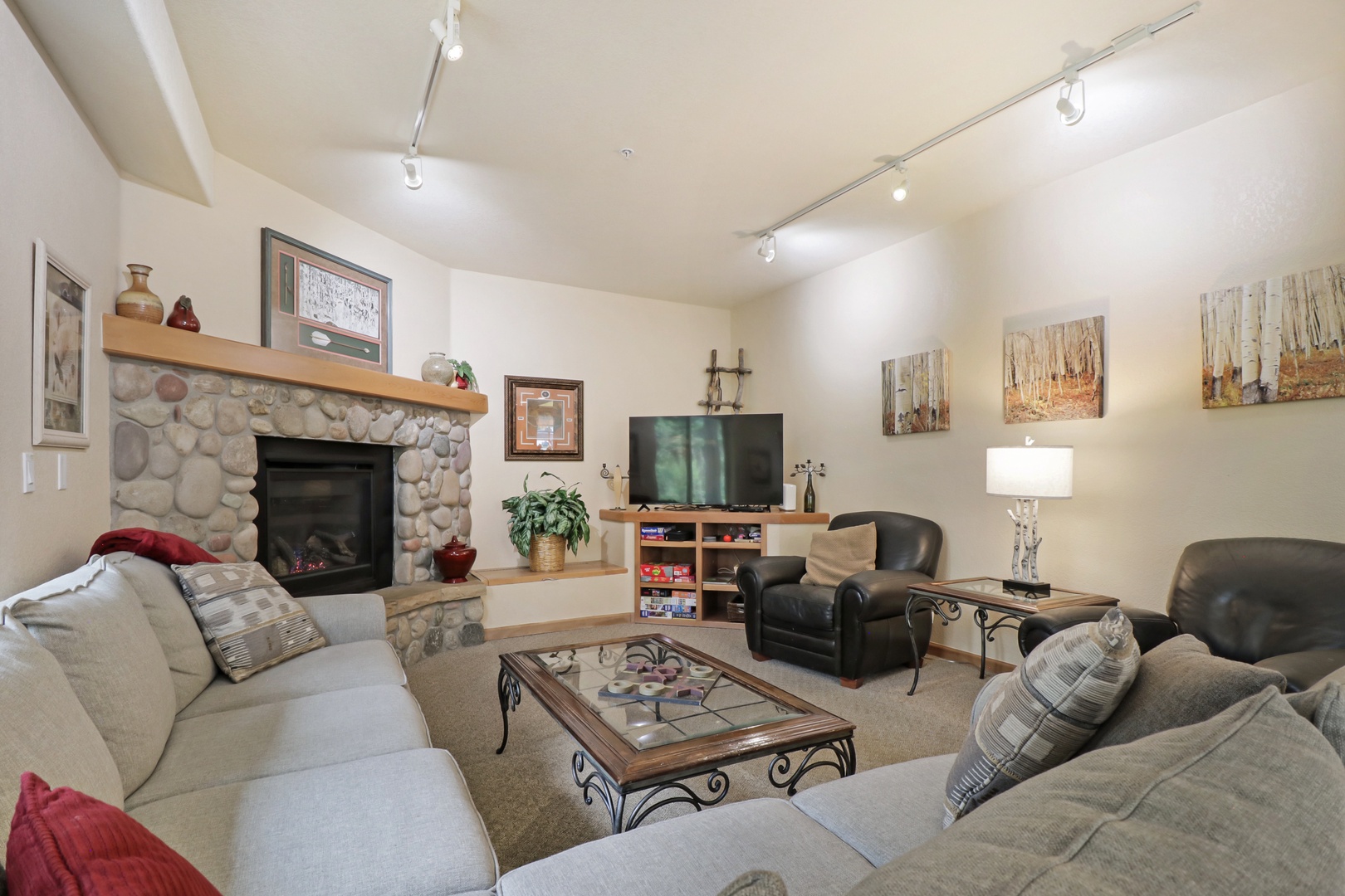 Unwind by your own stone fireplace surrounded by comfortable seating and warm lighting—your personal retreat after a day of adventure.