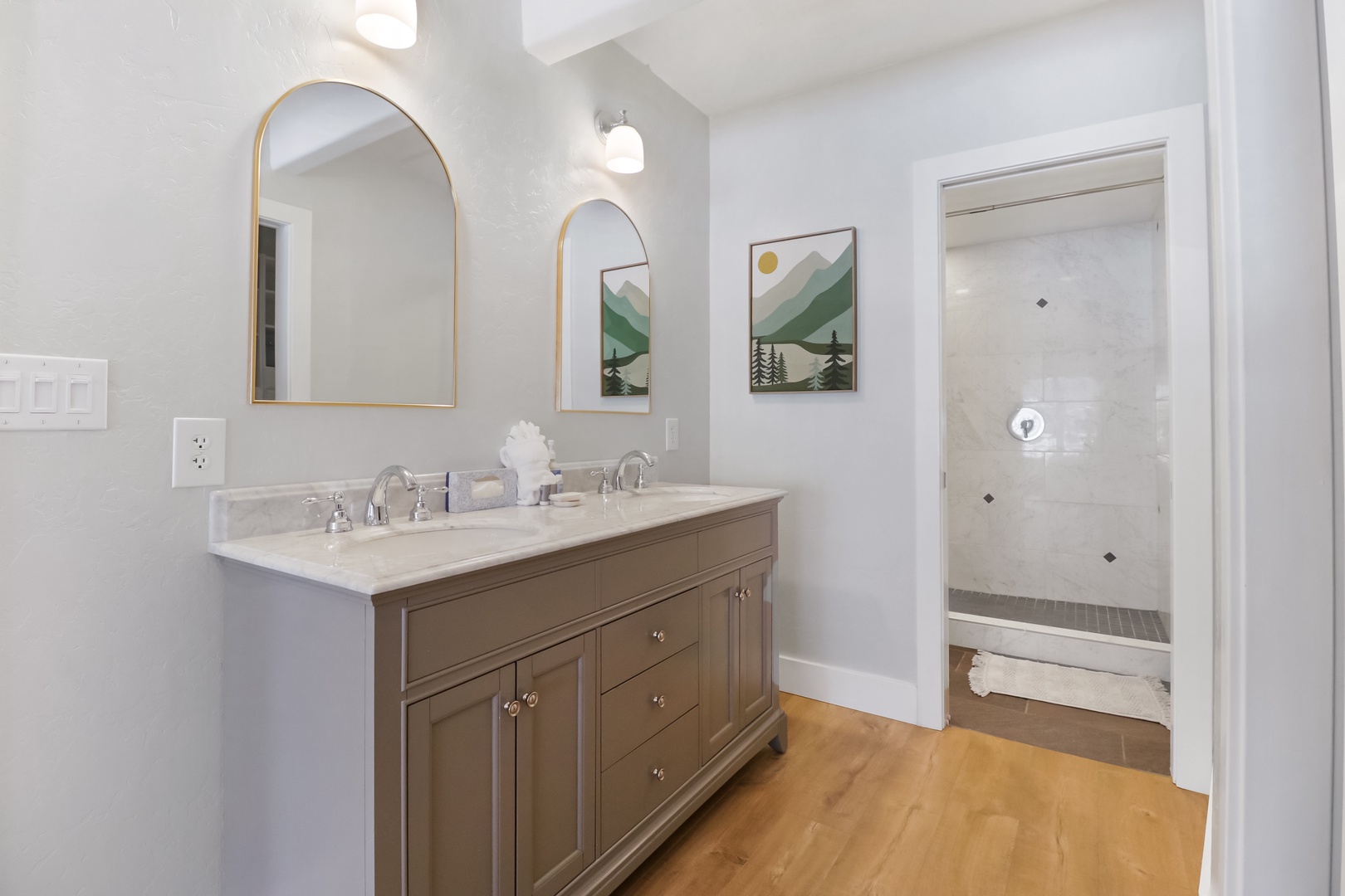 Unwind in your beautifully designed bathroom with dual vanities, elegant mirrors, and a spacious walk-in shower.