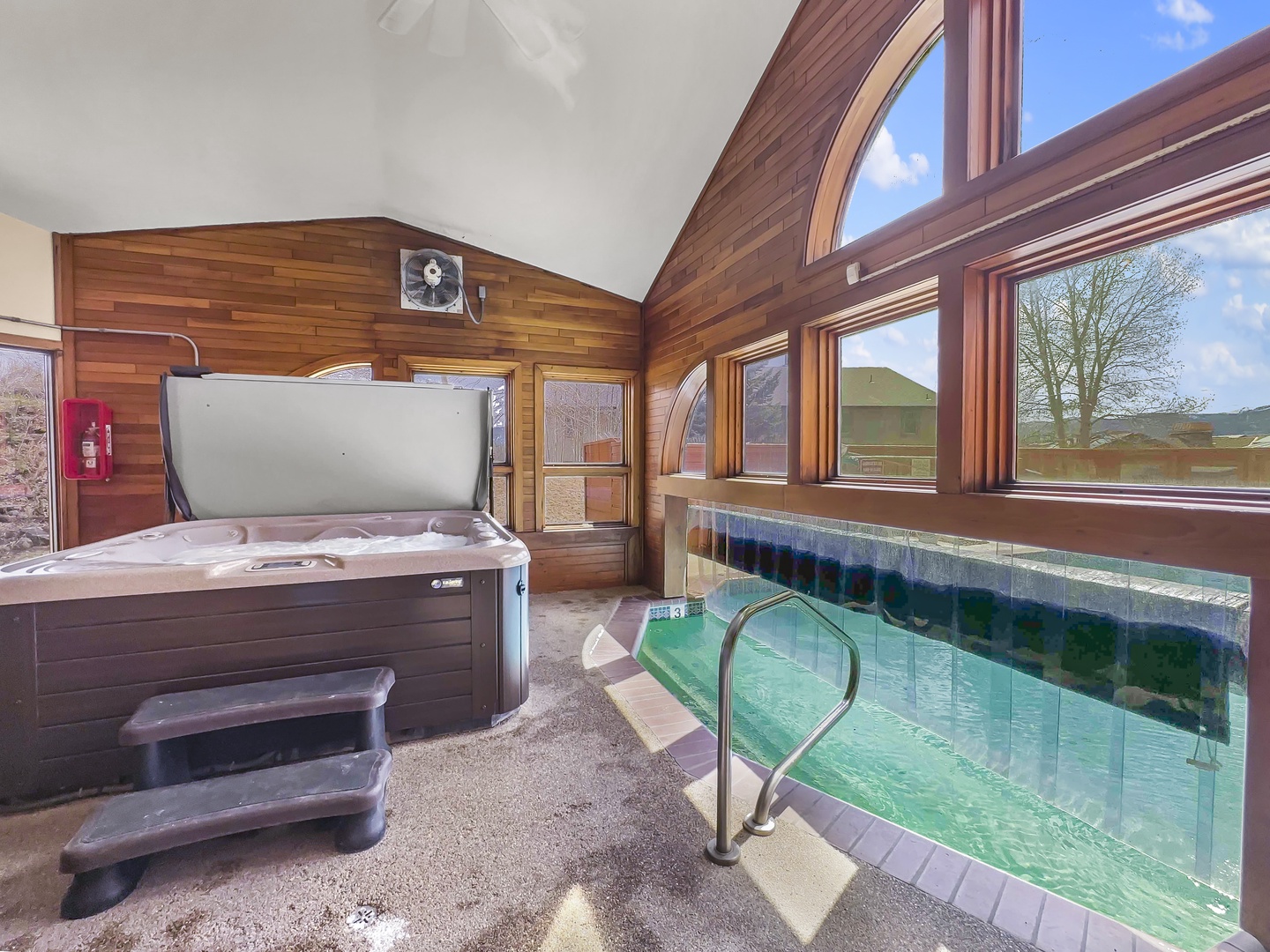Unwind in your shared wellness retreat with a soothing hot tub and indoor pool, surrounded by warm wood and natural light.
