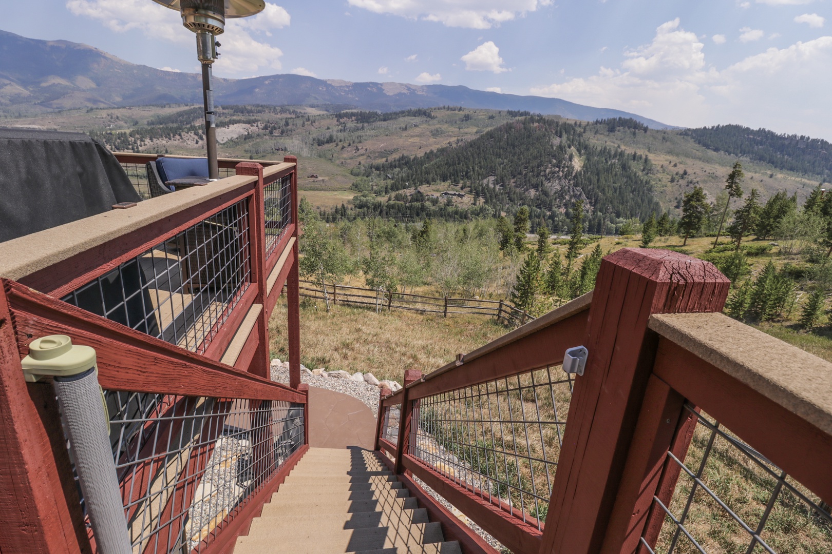 Sweeping mountain vistas stretch across rolling hills and forested valleys, creating a peaceful backdrop for your countryside retreat.