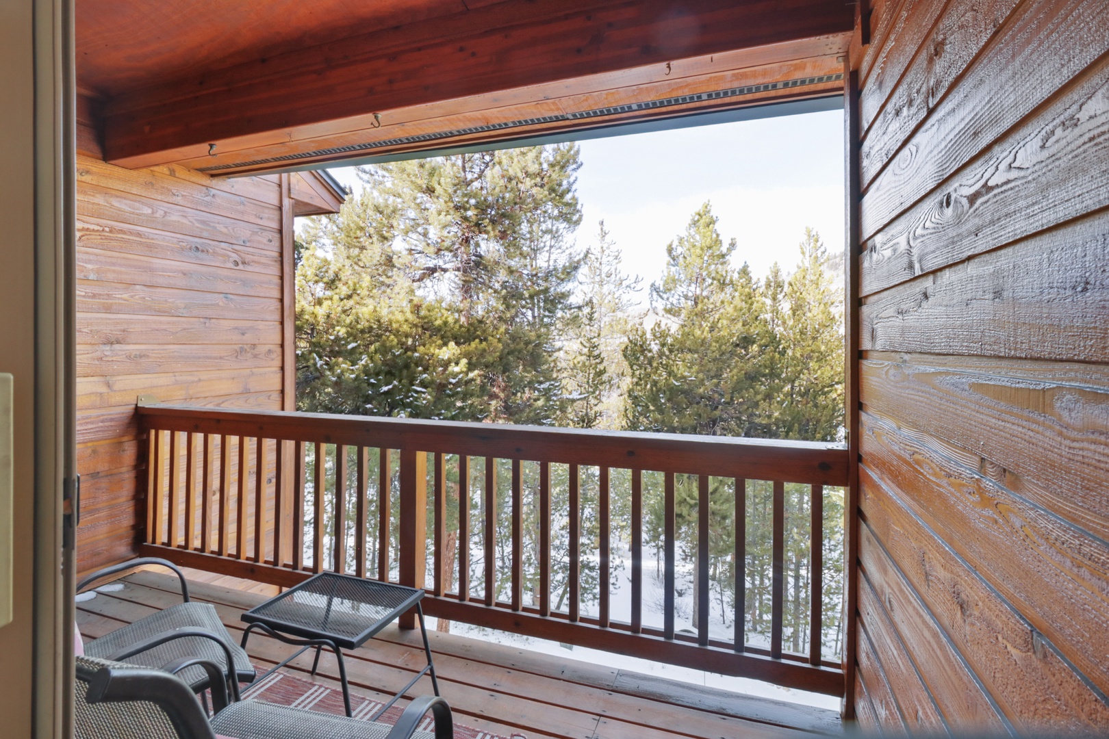 Step onto your private balcony and breathe in crisp mountain air while enjoying peaceful forest views from this cozy retreat.