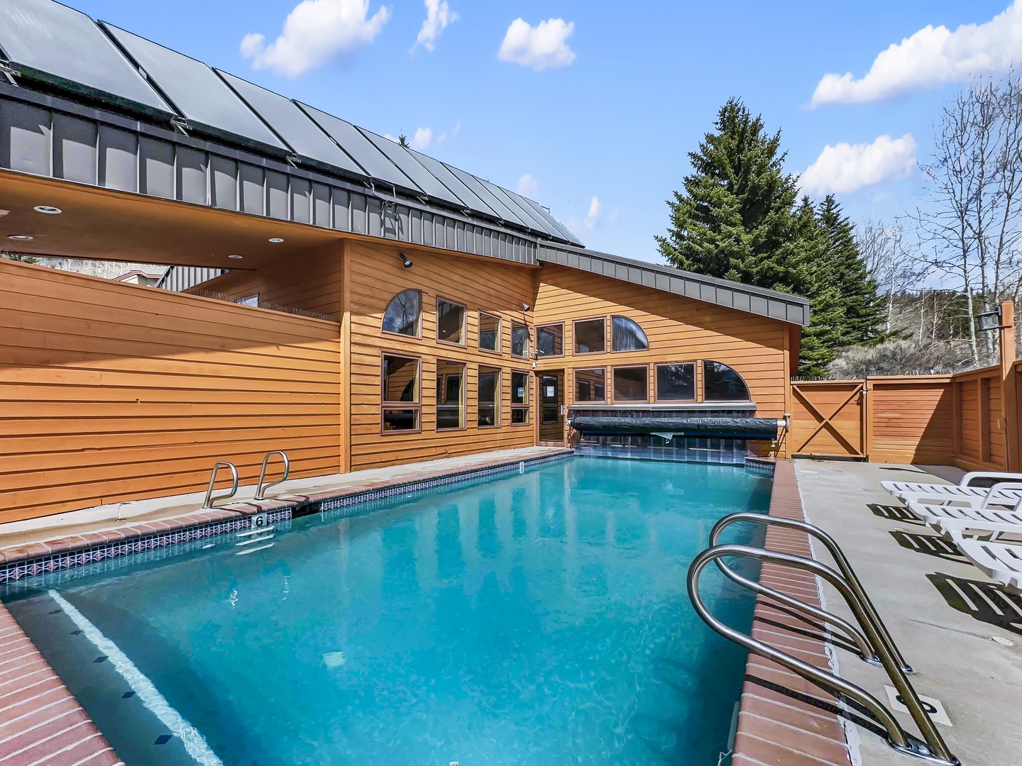 Dive into your community heated pool surrounded by stunning wood architecture and mountain views.