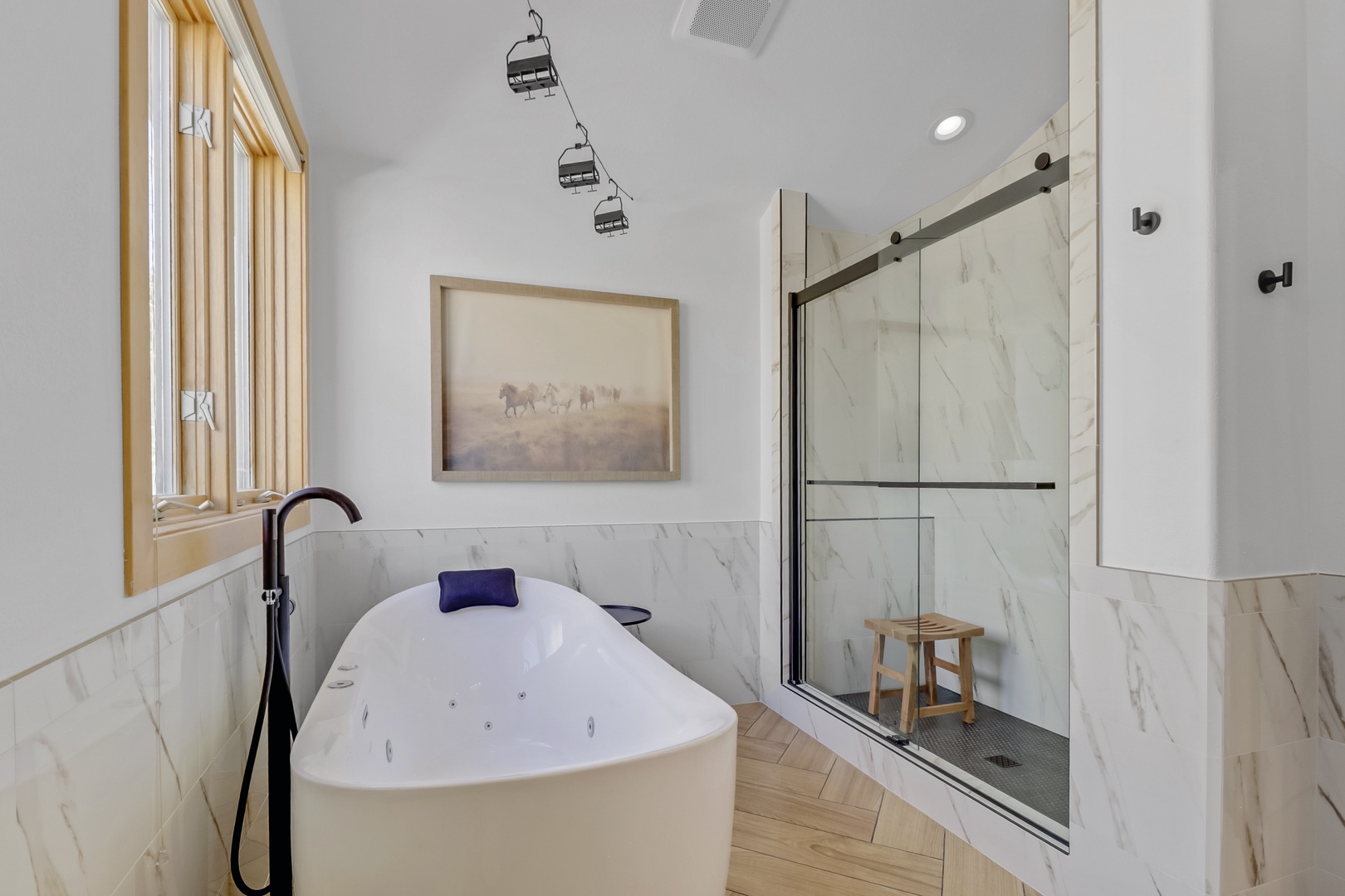 Luxurious marble bathroom with jetted, tempatrue controlled tub and spacious shower for your ultimate relaxation retreat.