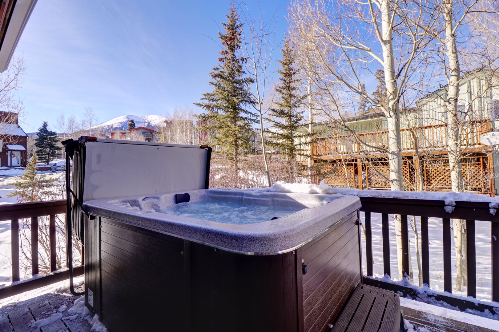 Soak in your private hot tub while snow-capped mountains create a stunning winter backdrop in this serene mountain setting.