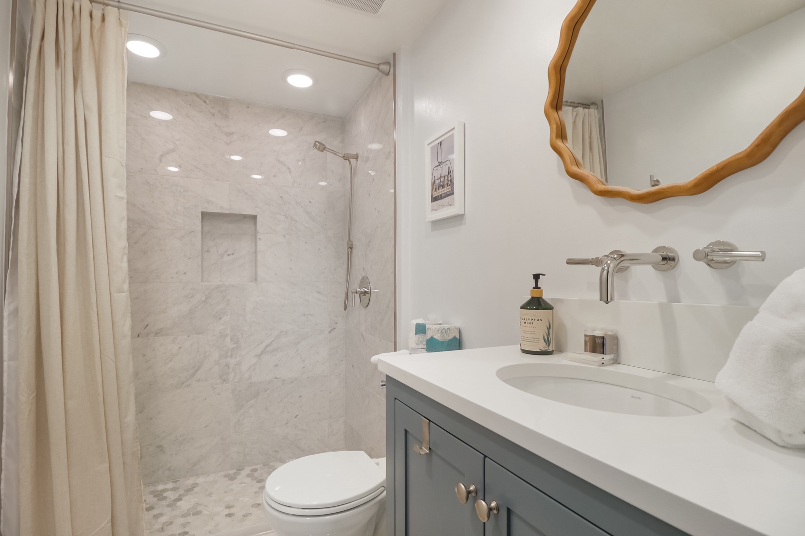 Step into your beautifully appointed bathroom featuring luxurious marble shower, elegant vanity, and thoughtful amenities for your comfort.