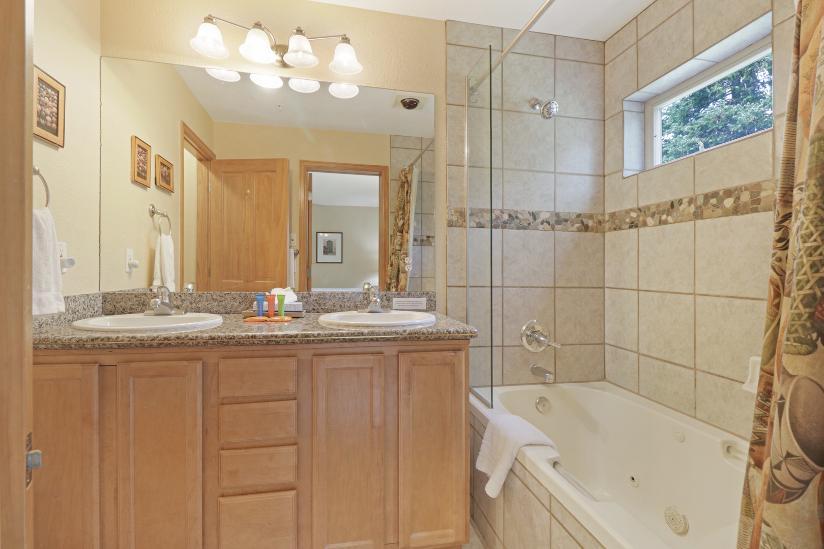 Soak your cares away in your spacious bathroom with dual vanities, a jetted tub, and a private shower—plus natural light from your garden view.