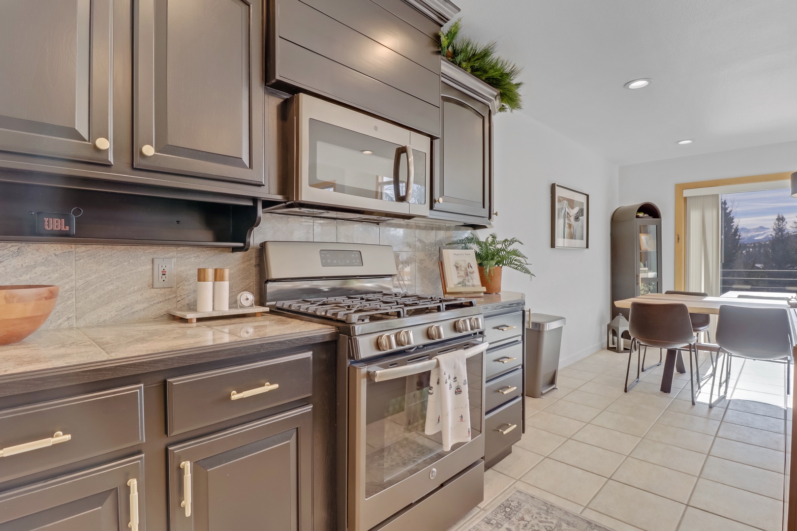 Your beautifully appointed kitchen awaits with stainless steel appliances and elegant cabinetry, perfect for preparing memorable meals.