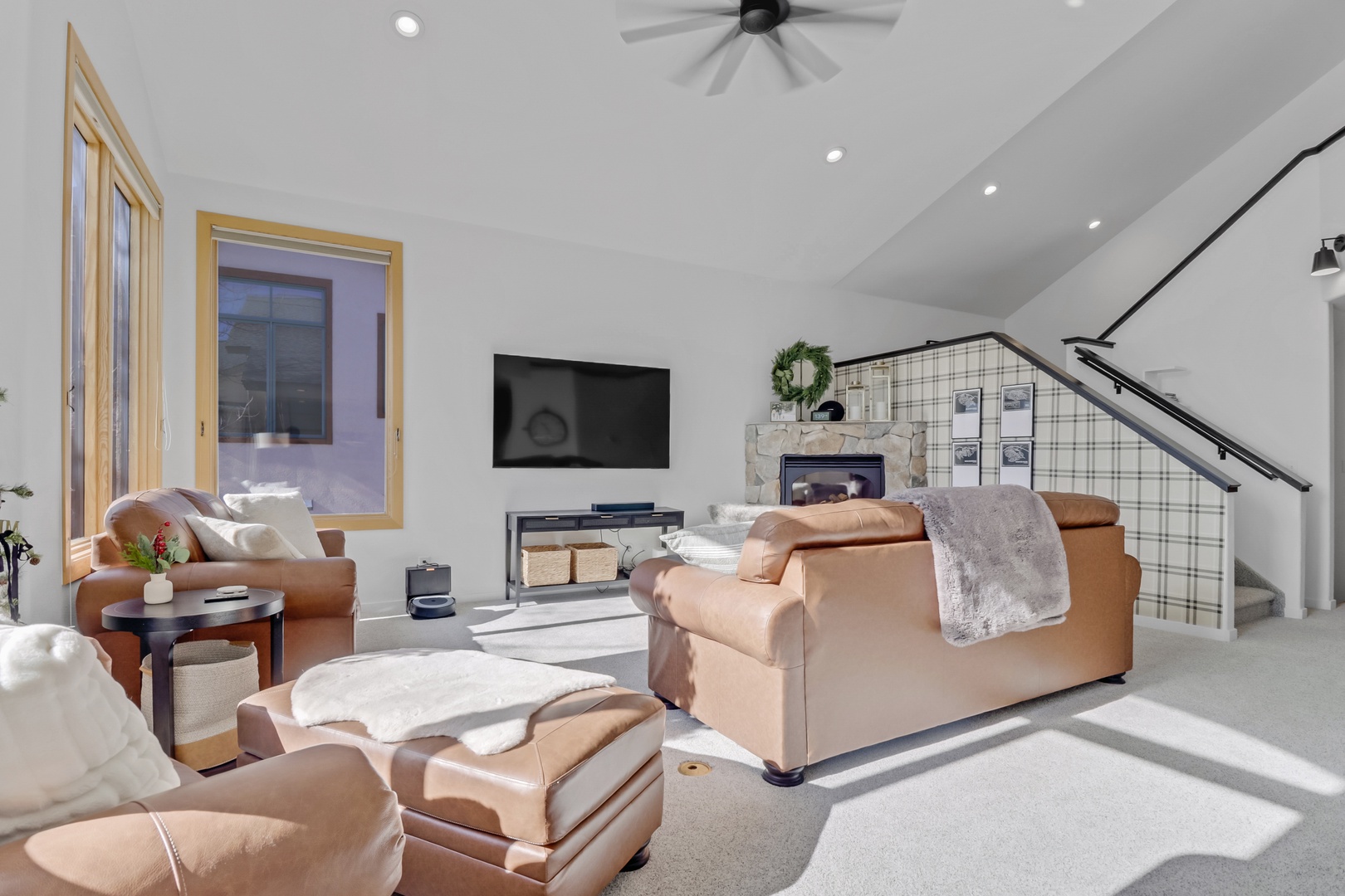 Sink into luxurious leather seating while enjoying your favorite shows on the large TV, with cozy throws perfect for relaxing evenings.