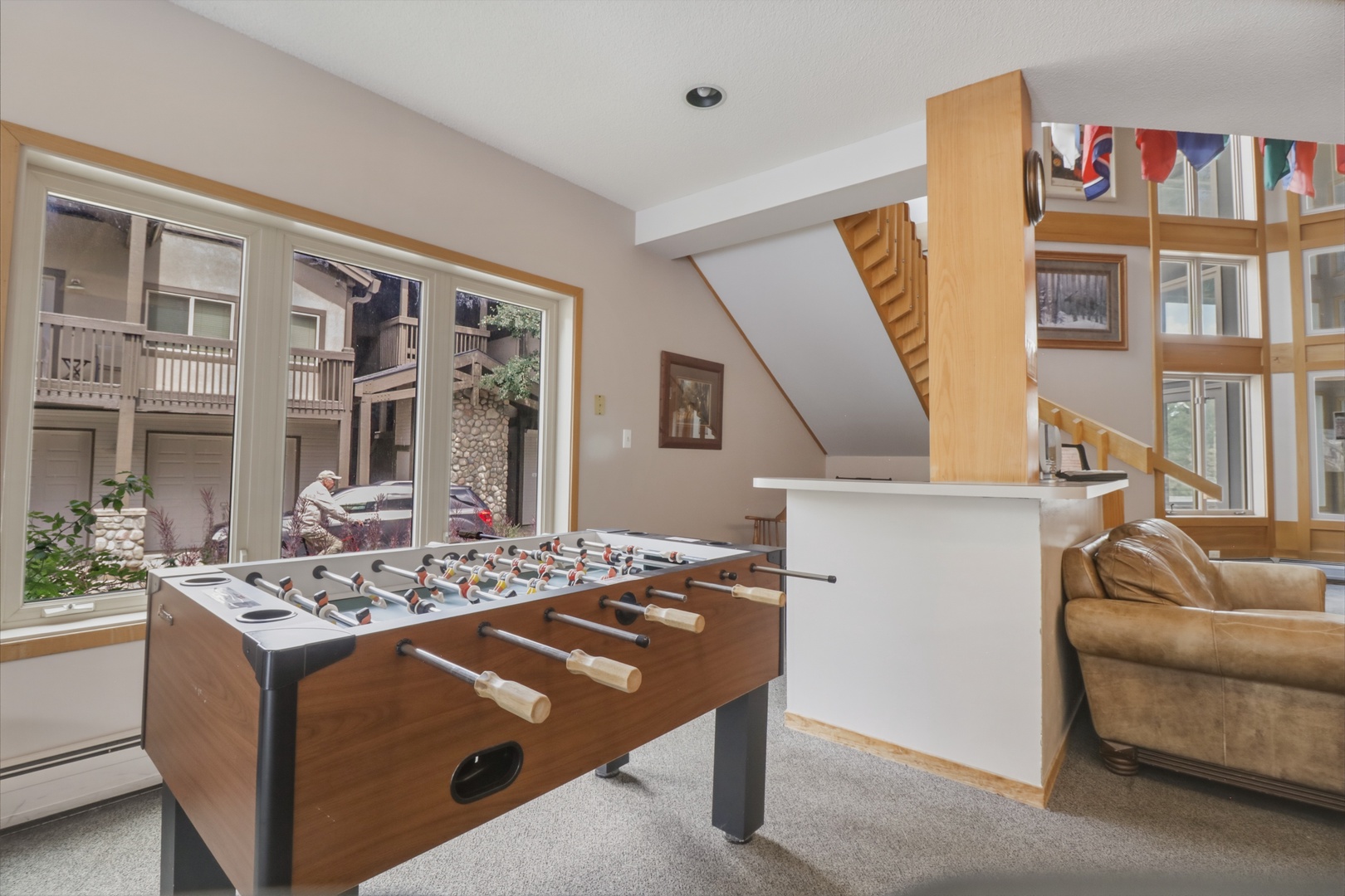 Challenge your friends to foosball in this bright, open game room where laughter and competition flow freely between friendly matches.