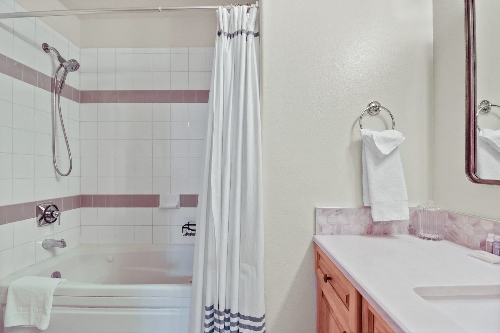 Step into your private bathroom with a relaxing tub-shower combo, fresh towels, and thoughtful touches for your comfort.