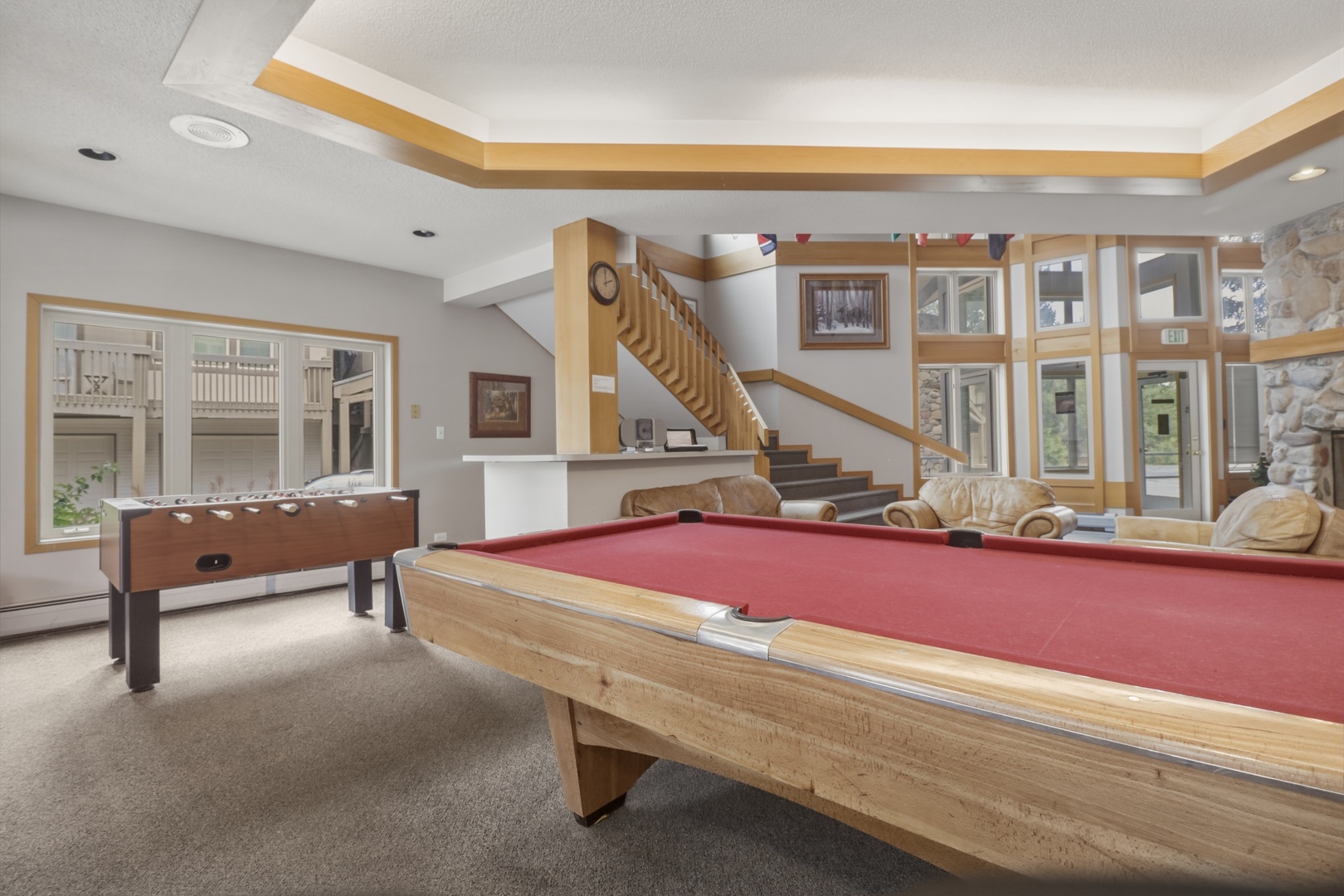 Challenge your friends to a game on the pool table or test your skills at foosball in this spacious game room, complete with comfortable seating and abundant natural light.