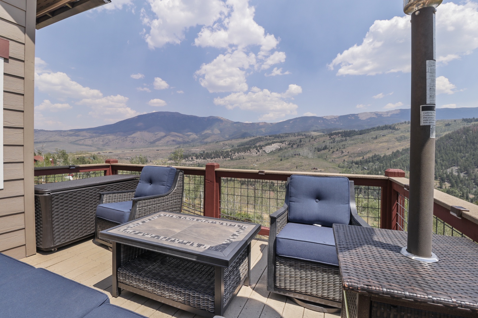 Panoramic mountain views sweep across rolling hills and valleys from your private deck. Sink into plush outdoor seating and breathe in the fresh air as you take in the natural landscape stretching to the horizon.