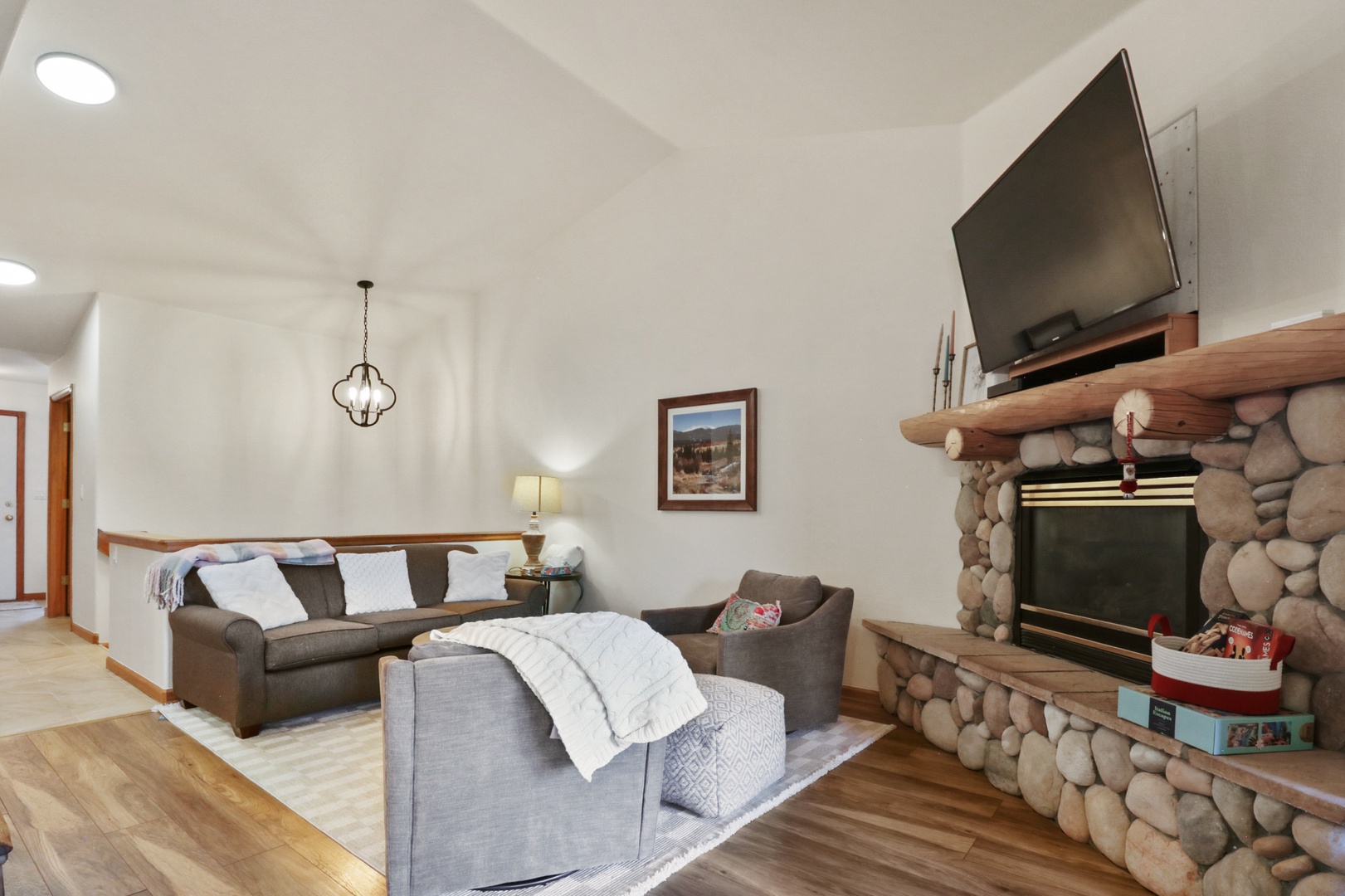 Unwind in your spacious living room with plush seating, cozy fireplace, and modern entertainment setup for perfect evenings in.