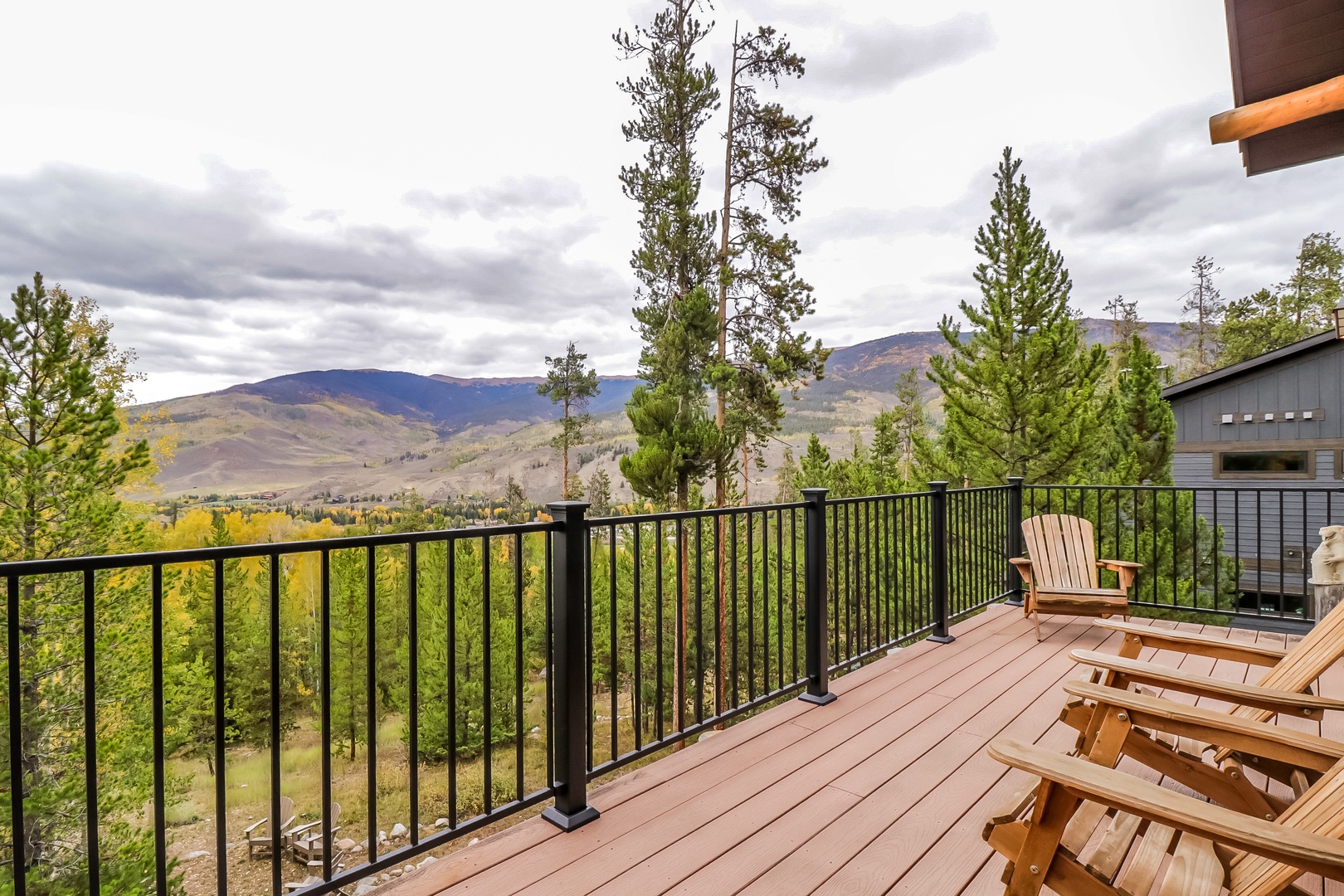 Unwind on your private deck with stunning mountain vistas stretching beyond towering pines, perfect for morning coffee or evening relaxation in fresh alpine air.
