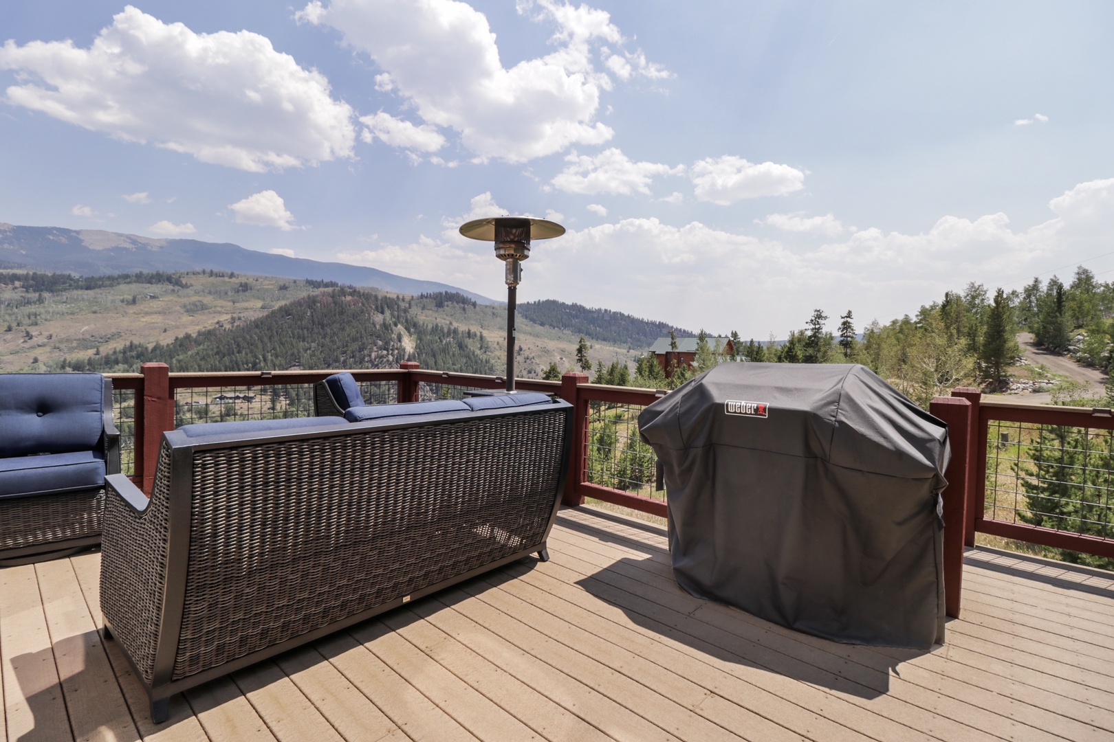Breathe in the mountain air on your private deck, where wicker seating, a Weber grill, and a cozy outdoor heater invite you to linger over meals with sweeping forested valley views.