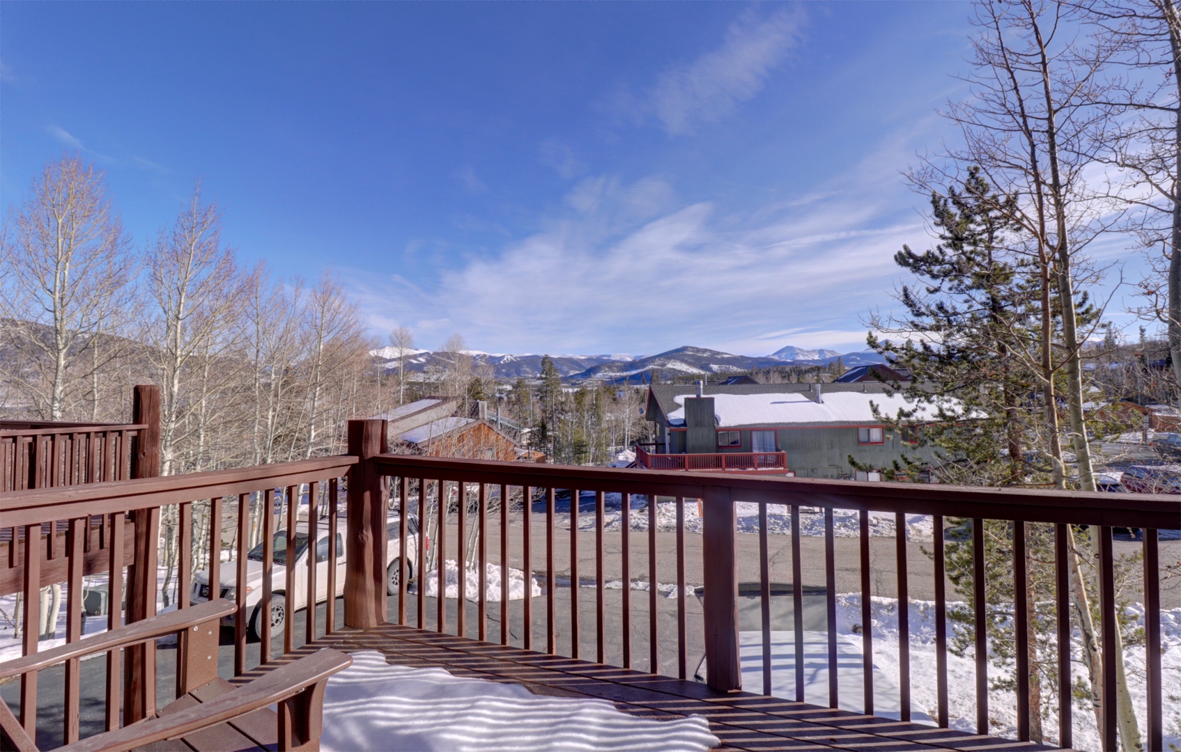 Step onto your private deck and breathe in the crisp mountain air while enjoying stunning views of snow-capped peaks and winter landscape.
