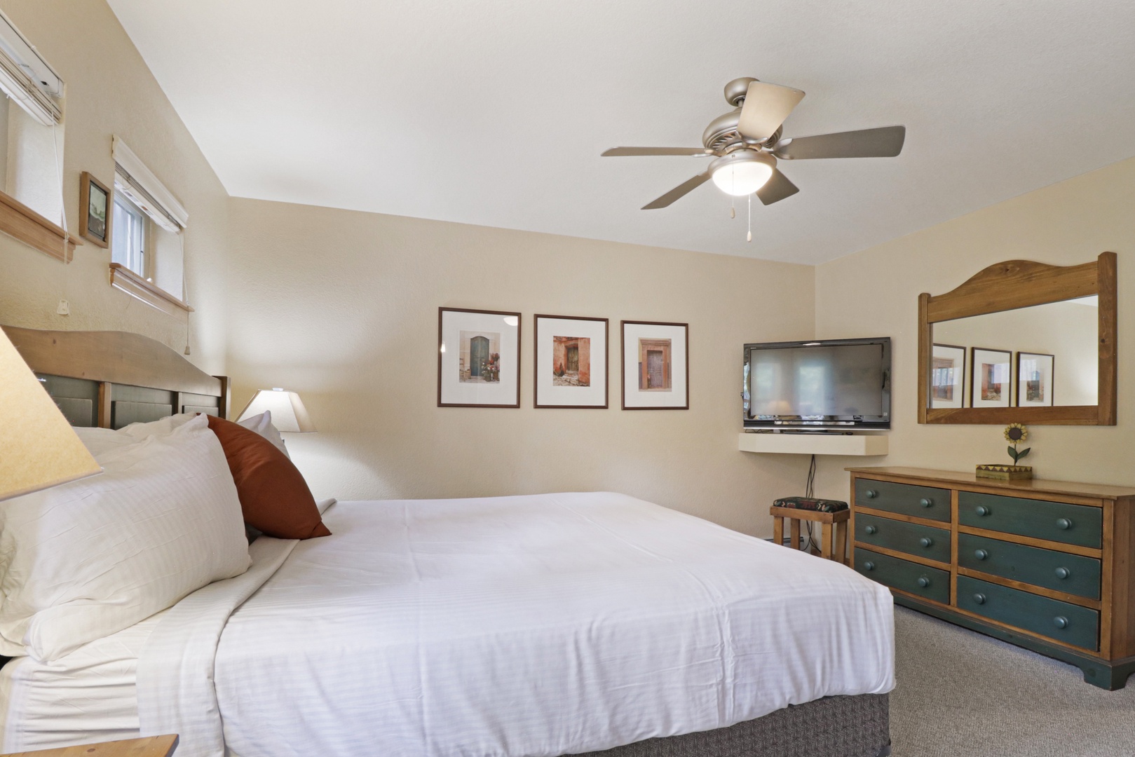 Sink into plush linens beneath the ceiling fan, where natural light fills your bedroom and thoughtful touches make it easy to settle in after a day of adventure.