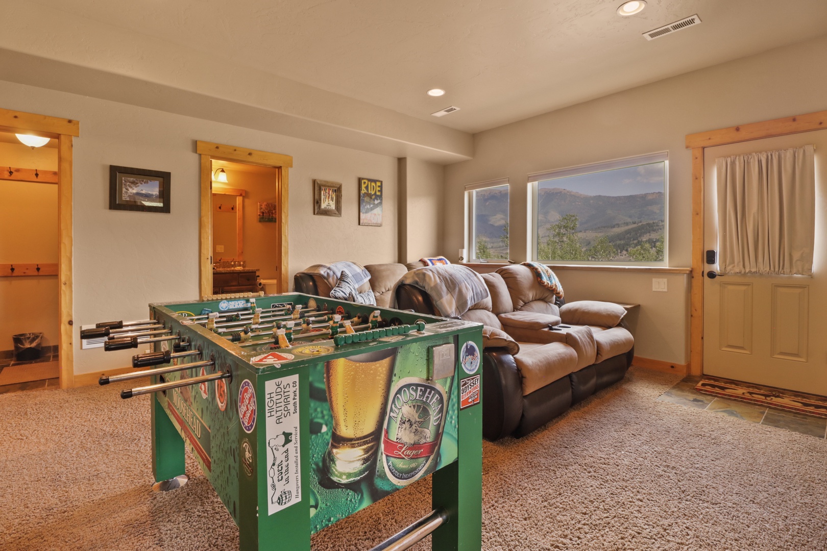 Challenge friends to a friendly match at the foosball table, then sink into the plush leather sofa while taking in real mountain views through expansive windows.