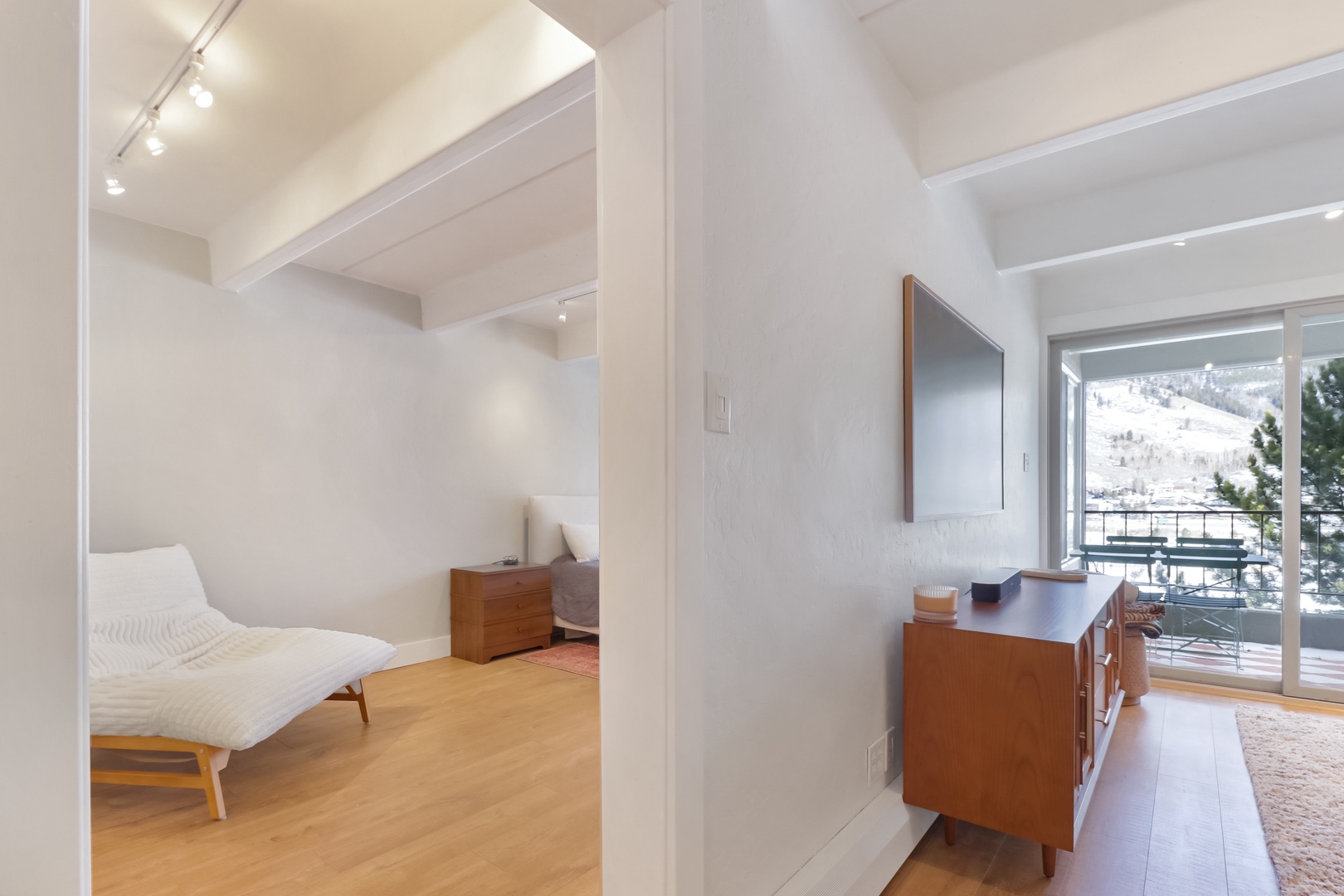 Unwind in your bright, modern retreat where warm wood tones meet sleek design, and mountain views frame your perfect alpine escape.