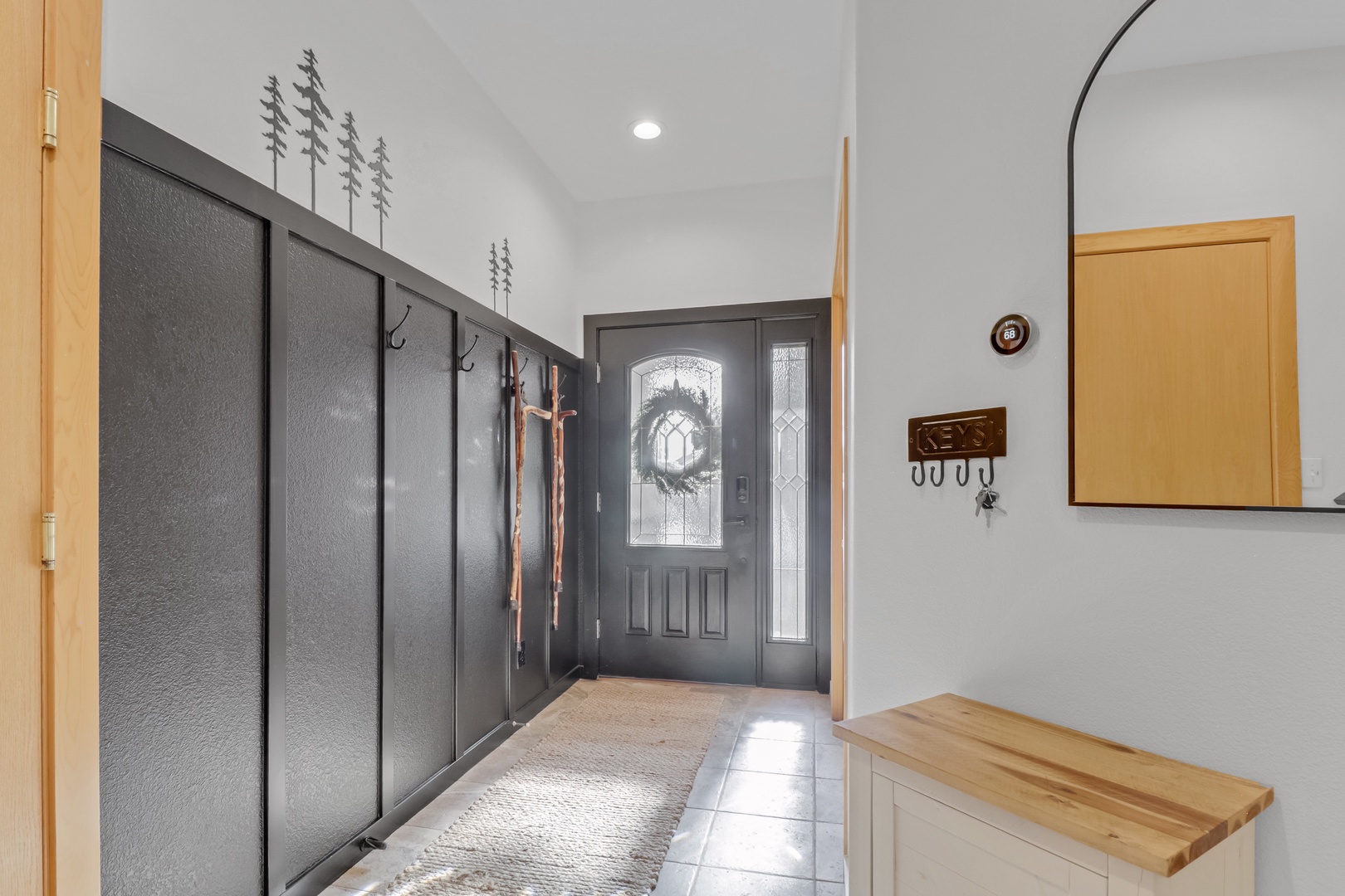 Step into your welcoming entryway with practical hooks for coats and gear, plus a handy bench for settling in after mountain adventures.