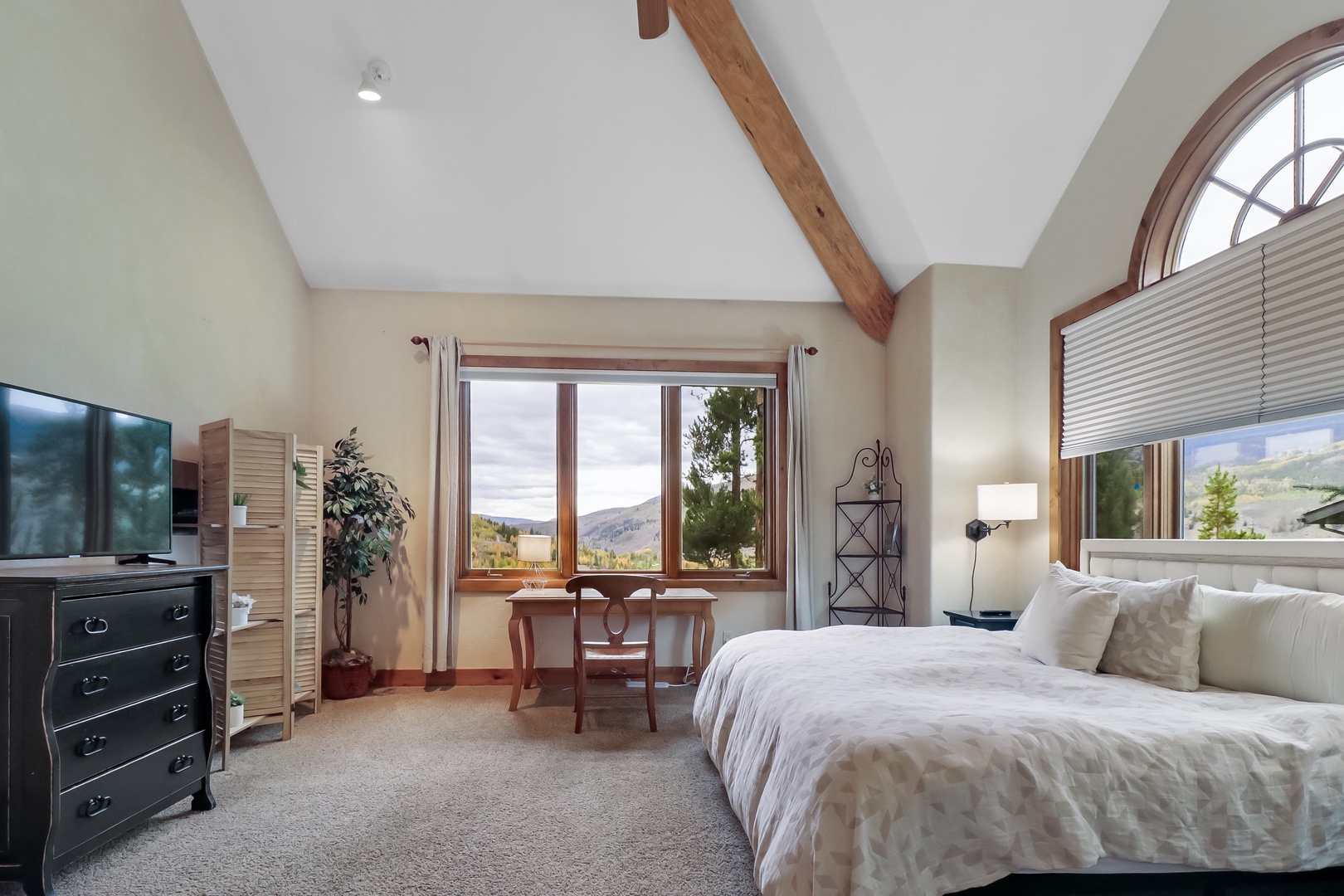Sink into crisp linens under vaulted wood-beam ceilings, where floor-to-ceiling windows frame mountain vistas that greet you each morning.