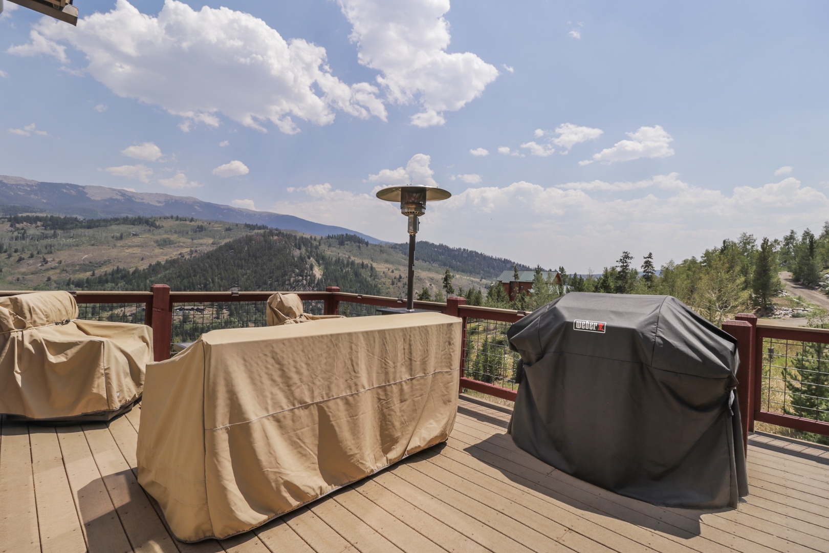 Sweeping mountain views frame your private deck, where a covered grill stands ready for evening cookouts under open skies. This is where you'll savor quiet mornings and unforgettable sunsets.